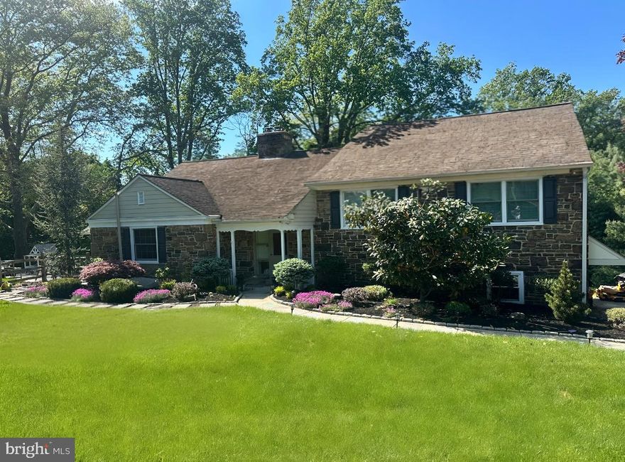 Welcome to 1708 Riverview Road — a beautiful home with many updates and amenities. This bright, sunny, spacious stone split-level home sits on over .76 acres in a wonderful neighborhood on a lovely street in Gladwyne.

The kitchen is large and eat-in, featuring stainless steel appliances, granite countertops, an island with stools, limestone floors, generous cabinet and storage space, double ovens, a tile backsplash, and an undermount sink. A door leads directly to a patio and outdoor space — perfect for enjoying meals or relaxing outside.

The Living Room and Dining Room combination features hardwood floors, a brick fireplace, and large picture windows that flood the space with natural light and sunshine.

A half flight down you will find a spacious Laundry Room with washer, dryer, laundry sink, and newer cabinets and countertops — ideal for storage and folding laundry. Across the hall is a very large storage closet with shelves and cabinets. You can also enter through the renovated 2-car Garage, which offers additional storage space. The home also features a newer HVAC system and a new septic system, giving you peace of mind for years to come.

The second level features a Primary Bedroom with a walk-in closet and an updated primary Bathroom, along with two additional bedrooms and a lovely hall Bathroom with a large closet. All bedrooms on this level have ceiling fans.

The top level offers a huge bedroom with great closet space, a ceiling fan, and an additional storage closet. The attic is floored, has a window, and provides even more storage space.

The lower level is above ground and beautifully finished, complete with a full bathroom. With two separate areas, this flexible space can serve as a Guest Suite, Family Room, Playroom, Gym, or Office — or more than one at the same time. An entire wall of built-ins provides ample storage, and an outside door opens directly to the grounds.

Enjoy this beautiful home in the award-winning Lower Merion School District, conveniently located close to major highways, shopping, libraries, Center City, and King of Prussia.