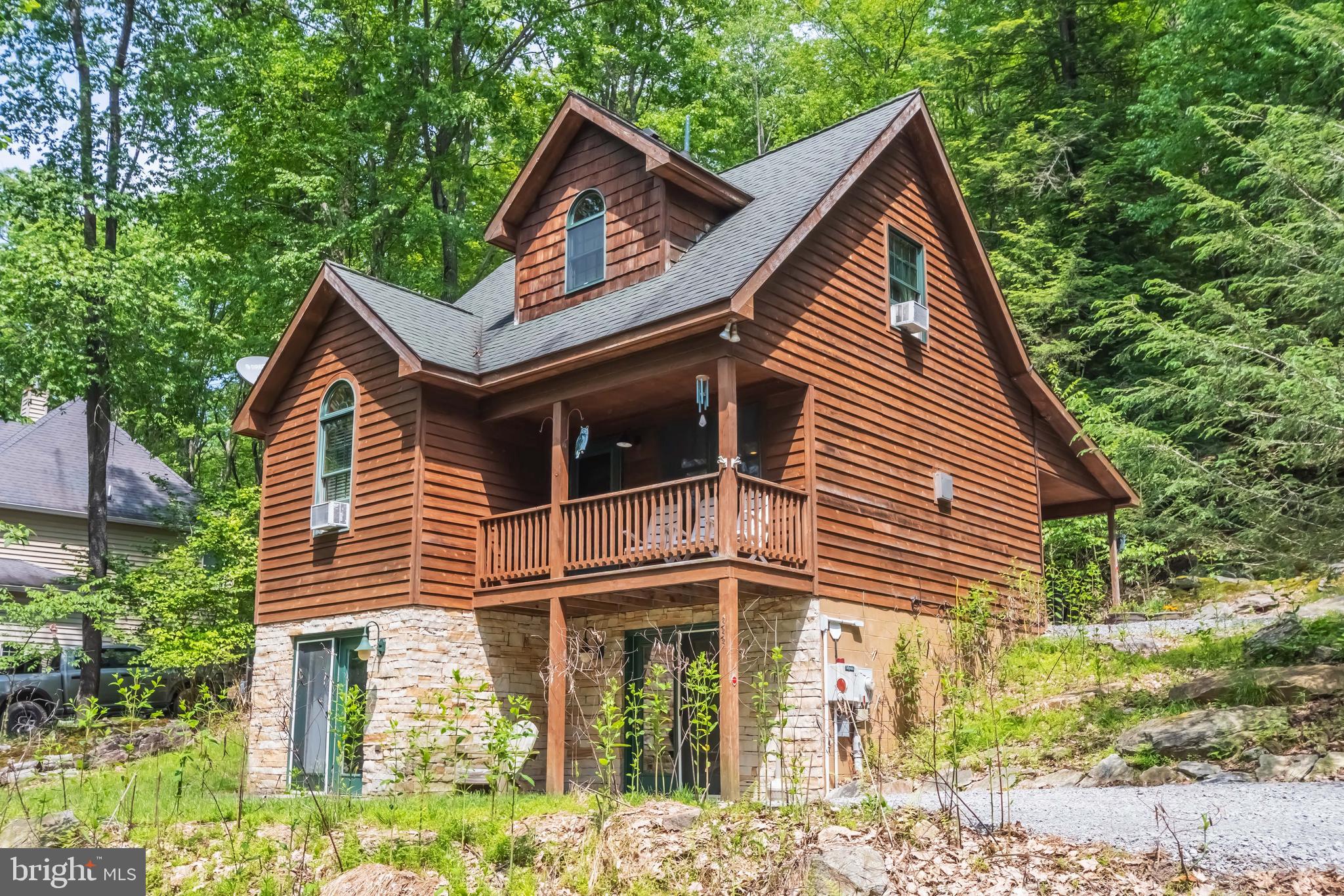 Charming cabin off the coveted Lake Shore Drive offering seasonal lake views. This home has three levels of living space, hardwood flooring and a nice fireplace. The lower level is totally finished with walk-out access. There are multiple covered porches plus a hot tub that are great outdoor spaces to enjoy year round. This home feels very secluded but is just minutes to Deep Creek Lake and Wisp Ski Resort. Hidden Treasure would be an ideal permanent residence or vacation home. Call today to preview!
