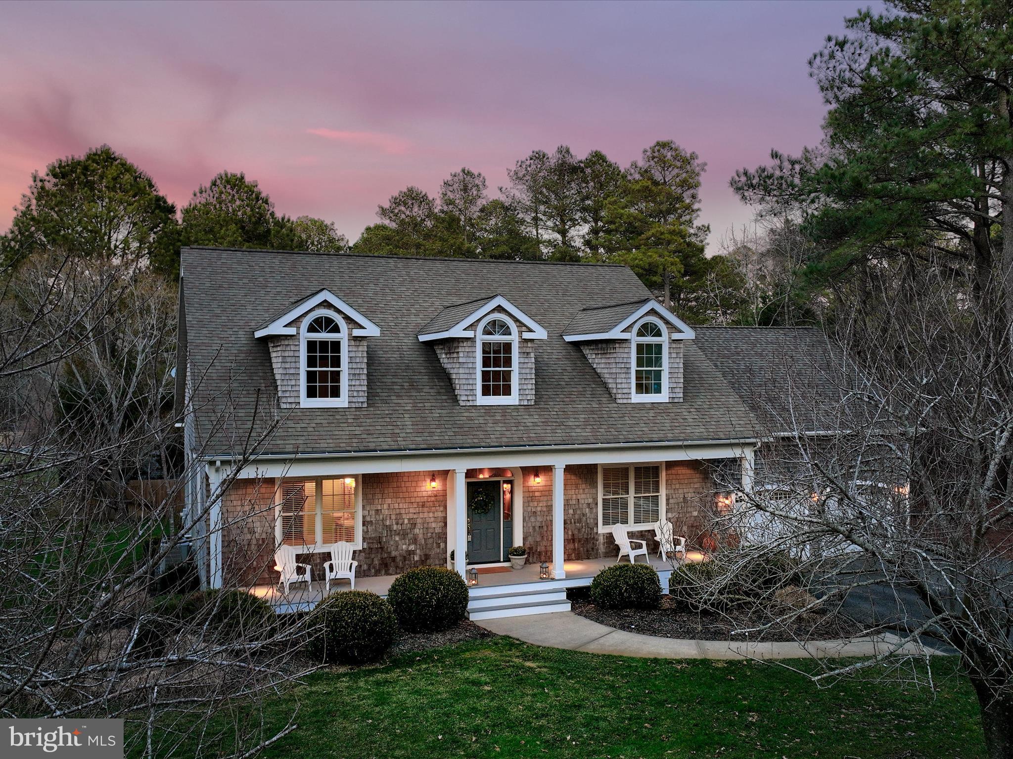 Back on the market with a New Price!
 Discover a rare opportunity in Piney Island, a peaceful, tree-lined community with water views and a convenient location close to Ocean City and Delaware beaches. This custom cedar-shake Cape Cod offers over 3,000 sq. ft. of finished living space, plus a full unfinished basement (approx. 1,722 sq. ft.) for future expansion.
The bright foyer welcomes you with gleaming hardwood floors, classic wainscoting, and a wide staircase. The open-concept layout features a spacious living/dining area with gas fireplace, a sunroom filled with natural light, and a chef’s kitchen with custom cabinetry, granite counters, and island seating. A mudroom leads to an oversized 2-car garage with additional attic storage.
The main level includes a large primary suite, home office, and half bath. Upstairs, find three bedrooms—including two with water-view window seats—plus a Jack-and-Jill bath and flexible bonus spaces for work, play, or storage.
Set on a generous half-acre lot, the outdoor space offers a deck, patio, and plenty of room to garden, play, or relax. With ample open space to add a pool, this could be the outdoor living space of your dreams.
Just minutes from Route 113, Ocean City, and Delaware beaches—this hidden gem offers serenity and convenience. Don’t miss it—schedule your showing today!