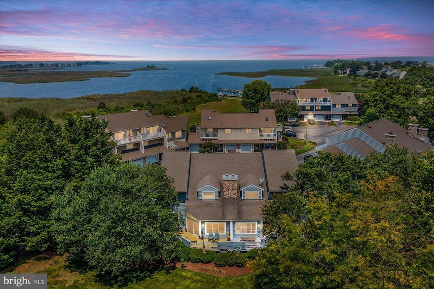 Waterfront Community! Completely updated & renovated to perfection, this meticulously maintained end-unit garage townhome in the waterfront community of Bayview at Kent Narrows is the one you have been waiting for! Enjoy views and spectacular sunsets from the upper balconies, and entertain in style on the fabulous wrap-around deck. Located at the edge of the Chester River, a private marina and your own boat slip convey to ensure the ultimate coastal lifestyle. No expense has been spared in updating - from the luxury Italian Bertazzoni appliances in the fully renovated kitchen to the four light-filled oversized sliders and the incredible shower in the primary suite - this home is simply breathtaking. All new vinyl plank flooring is found throughout the main level, where an open-concept design creates an easy flow. The eat-in kitchen offers granite counters & backsplash, modern white cabinetry, under-counter lighting, dual pantry closets, and those incredible top-of-the-line appliances. There is a sunny dining room that steps down to the 2-story living area. complete with a wood burning fireplace for cozy nights. Both the dining & living rooms lead to the spacious deck for easy grilling and entertaining. This level also includes a re-designed laundry closet and a gorgeous powder room. An open staircase leads to the upper level and the amazing primary suite. Featuring private access to the sun deck, a spacious well-appointed walk-in closet, and a tiled ensuite bath with two separate vanities, and an oversized shower to rival the best- dual shower heads, waterfall, massagers, and sprayers. The second bedroom also has access to the balcony and amazing water views, as well as a newly installed closet system. There is another updated bath on this level, as well as a loft space perfect for a second family room or the ability to easily create an additional bedroom. Community amenities include an outdoor pool, secure boat storage, and a waterfront gazebo. Enjoy easy access to Cross Island Trail for a quick stroll or bike ride to shopping and restaurants. Easy access to Route 50.