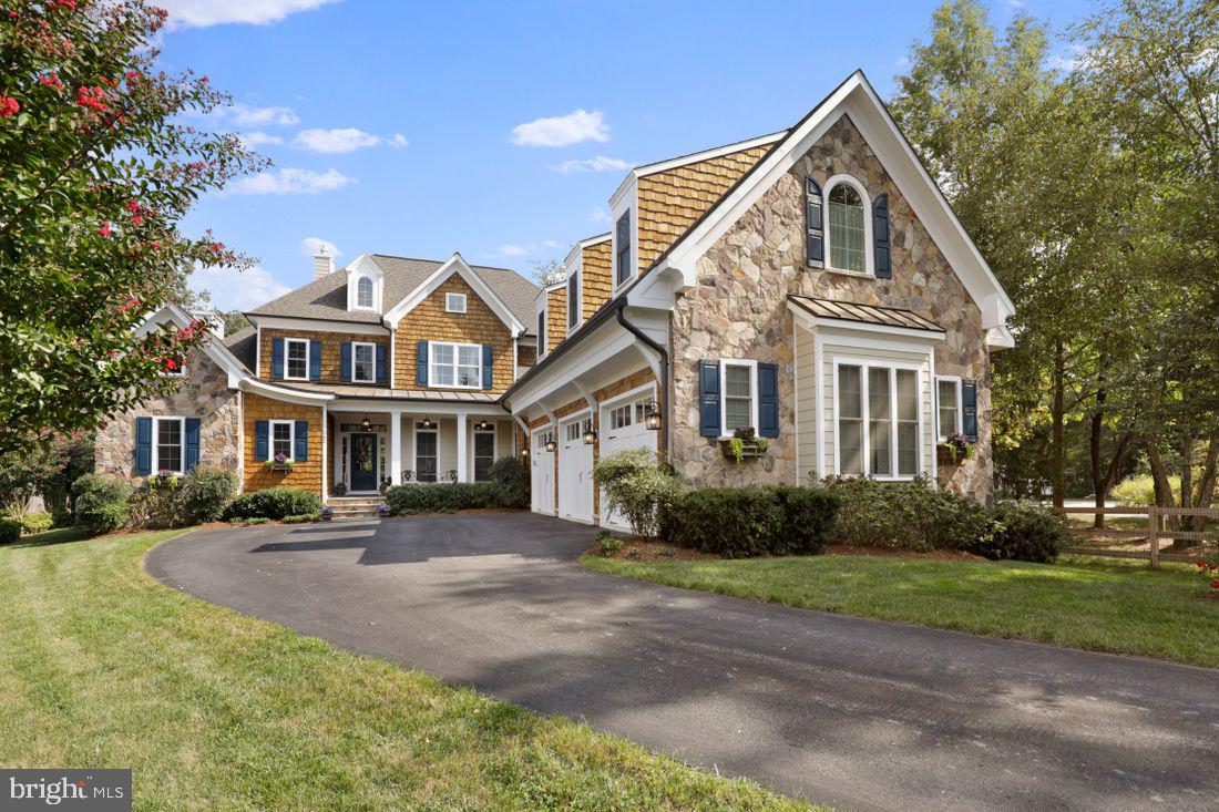 Severna Park Waterfront!
This stunning custom built 6,000 square foot home with deep water pier, saltwater pool, and large outdoor entertaining areas. This 1.2-acre resort-like property is located on a private quiet, cul-de-sac, with 6 bedrooms and 6 1/2 baths. The exterior is a combination of stone, cedar shake, and hardie plank siding and extensive crown and trim detail work. A bluestone porch welcomes you as you enter the light filled, vaulted foyer and living room. Large glass windows and soaring gas fireplace make this a beautiful setting for the views to a private, professionally landscaped garden, a fenced yard with pool and outdoor kitchen.
The attached open concept kitchen boasts granite counters, custom cabinets, stainless steel appliances and large pantry. The massive island has a cozy seating area for 4. There is also an informal eat-in dining area with huge windows that overlook the pool, private woods, yard, and massive Brazilian hardwood deck, perfect for your morning coffee, cocktails, or large group entertaining and outdoor seating. Adjacent to this lovely kitchen is a butler's pantry and wet bar, which opens to the formal dining room. A separate den just off the main floor kitchen and dining area has a second gas fireplace and large windows that also overlook the back yard, deck, and pool areas.
Additional first floor features consist of wide plank white oak flooring and custom molding details with 10' ceilings. This level also has expansive master suite with a third gas fireplace, vaulted en-suite bath with jetted tub and separate shower, and large his and hers closets. The master bedroom has a door leading to main floor deck. The master suite, den, large office, laundry room and the 3-car garage make 1st floor living exceptionally easy.
When you step up the elegant staircase and cross the bridge overlooking the main living room area you will find three additional large bedrooms, each with their own en-suite baths and 9' ceilings with extensive crown molding and trim work. A massive office/game room or au-pair suite complete with a full bath, wet bar, or kitchenette accessible from a separate second staircase, making this space on opportunity for whatever you can dream of!
On the lower level is a private gym and an 1800 SF large 2-bedroom 1 bath apartment, with hardwood floors, a full kitchen, laundry, dining area, and living room area with large windows. Walkout the separate entrance to a private patio overlooking the pool, woods, and garden area. This makes a perfect situation for extended family or rental income.
Stroll or golf cart down the relaxing woodland gravel path to your own private deep-water pier with 2 slips and beautiful views of the Magothy River.
The backyard has a custom-built saltwater pool, travertine patio, a tranquil pond with waterfall, fish and lily pads. A gas grill and outdoor kitchen with plenty of seating makes entertaining a breeze.
All Blue Ribbon Schools!
A Must See!