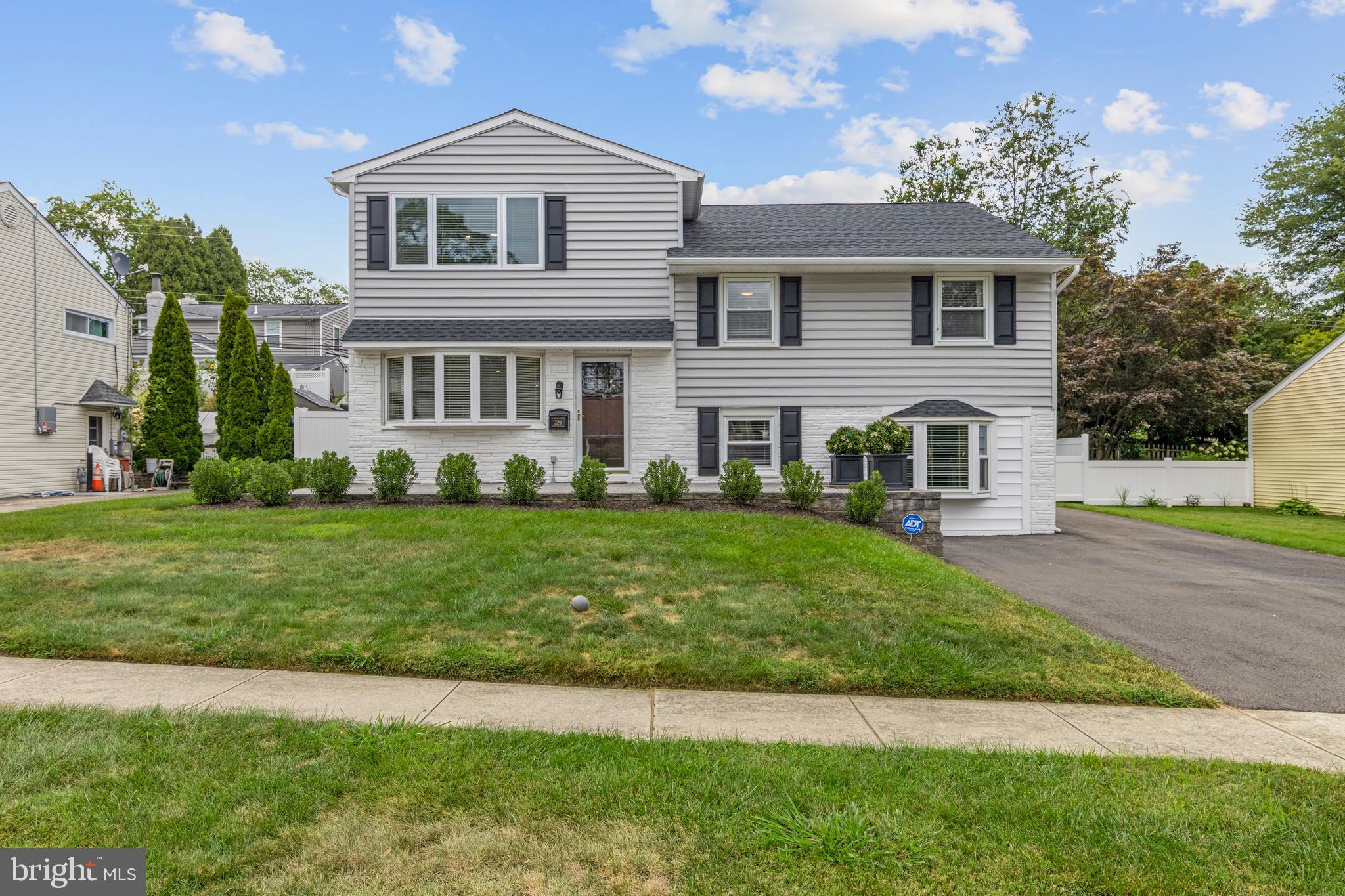 Move-in ready and fully reimagined over the past four years, 329 Williams Road offers a turnkey opportunity in sought-after Radnor Township. This Bryn Mawr home has received major updates inside and out, blending modern systems, thoughtful renovations, and expanded living space with timeless comfort. Situated in a walkable neighborhood near Clem Macrone Park, restaurants, and shops, the design also offers more square footage than many homes in the area thanks to prior extensions—including the dining room and the primary suite office/sitting room at the back of the house—spaces further enhanced by the current owners.
Since 2021, the home has undergone a comprehensive transformation. The main and lower levels were fully renovated with all new HVAC, plumbing, electrical, insulation, lighting, and flooring. The main level offers an inviting layout, with the kitchen centered between the dining room and living room to create a true open-concept flow. The 2021 kitchen renovation included gorgeous Century cabinetry, Colonial Marble & Granite countertops, tiled backsplash, new sink and faucet, GE Profile appliances, Avalon flooring, and a large center island with seating for four. Bay windows at both the front living room and rear dining room flood the space with natural light, while sliding doors from the dining room open to a side patio for easy indoor-outdoor living.
The lower level, remodeled in 2021, was transformed from former garage space into a large family/TV room with custom built-in bookcases surrounding a cozy gas fireplace. With full egress and multiple windows for natural light, this comfortable area is a great gathering space for watching football, movies, or playing games. Ample storage, a half bath, and a laundry room with GE Profile washer and dryer (2025) complete the level.
An addition completed in 2022 created the top-floor primary suite. This bright retreat offers a seamless layout flowing from the bedroom into an ensuite bath with a tiled walk-in shower and double-sink vanity. A generous walk-in closet with custom Container Store built-ins provides excellent storage, while a sitting room/office/gym at the rear of the space adds flexibility. The privateness of this entire level enhances the sense of retreat, making it a true sanctuary within the home.
Down a half flight of stairs is Upper Level 1, which includes three additional bedrooms and a remodeled hall bath with a bathtub. Container Store closets (2019) and natural light enhance each room.
The property’s curb appeal and outdoor spaces have been thoughtfully updated to enhance the charm and maximize privacy and year-round enjoyment, while extensive exterior upgrades make the home feel virtually brand new. A fenced-in yard, new back patio (2025), and landscaped front and side yards (2024) create a private setting with space for play and entertaining. A large storage shed, attached to the back of the home, keeps outdoor items neatly organized. Driveway parking adds everyday convenience.
Nearly every major system has been updated, offering peace of mind for the next owner. Improvements between 2021 and 2025 include a new roof, siding and exterior paint, windows, exterior doors, driveway, front porch/patio, fencing, gutters, HVAC system, water heater, insulation, plumbing, and electrical. Security is covered with a new ADT system (2025). With all of these updates, the “guts” of the house are essentially brand new.
Located in the top-rated Radnor School District, the home is centrally positioned with easy access to Wayne, Haverford, and Ardmore. Proximity to Clem Macrone Park, a walkable neighborhood with restaurants and shops up the street, and just one mile to the Rosemont train station with service to Philadelphia and New York City, plus close access to I-476 for easy commutes, all add to the appeal—balancing convenience with community charm.
