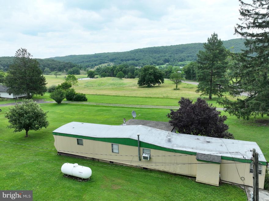LET THE FUN BEGIN IN CAPON BRIDGE WV! JUST 37 MINUTES FROM WINCHESTER AND CONVENIENTLY LOCATED ON ROUTE 50 WEST. THIS UNIQUE PROPERTY OFFERS THE PERFECT ESCAPE, WHETHER YOU'RE LOOKING FOR A WEEKEND RETREAT OR A FULL-TIME RESIDENCE. THERE'S NO HOA AND THE LAND IS FULLY USABLE WITH BEAUTIFUL VIEWS. THE 1974 MOBILE HOME IS MOVE-IN READY AND THERE'S A CHARMING TINY HOME TUCKED AWAY IN THE UPPER BACKYARD--COMPLETE WITH A BAR, PERFECT FOR CARD GAMES, SLEEP-OVER, OR RELAXING WITH FRIENDS. ENJOY THE EXPANSIVE PARILLION, IDEAL FOR ENTERTAINING OR EVEN HOSTING EVENTS--IT HAS PREVIOUSLY SERVED AS A LOVELY WEDDING VENUE. THE PROPERTY ALSO INCLUDES MULTIPLE OUTBUILDINGS ALONG WITH WELL, SEPTIC, AND ELECTRIC UTILITIES ALREADY IN PLACE. THIS VERSATILE, MULTI-USE PROPERTY WHERE COUNTLESS GOOD TIMES HAVE BEEN HAD--AND EVEN MORE ARE WAITING TO BE MADE. WHETHER YOU'RE COMING FOR THE WEEKEND OR PLANNING TO STAY A LIFETIME, THIS IS THE ONE. CROSS THE STATE LINE AND COME SEE FOR YOURSELF. YOU WON'T WANT TO LEAVE