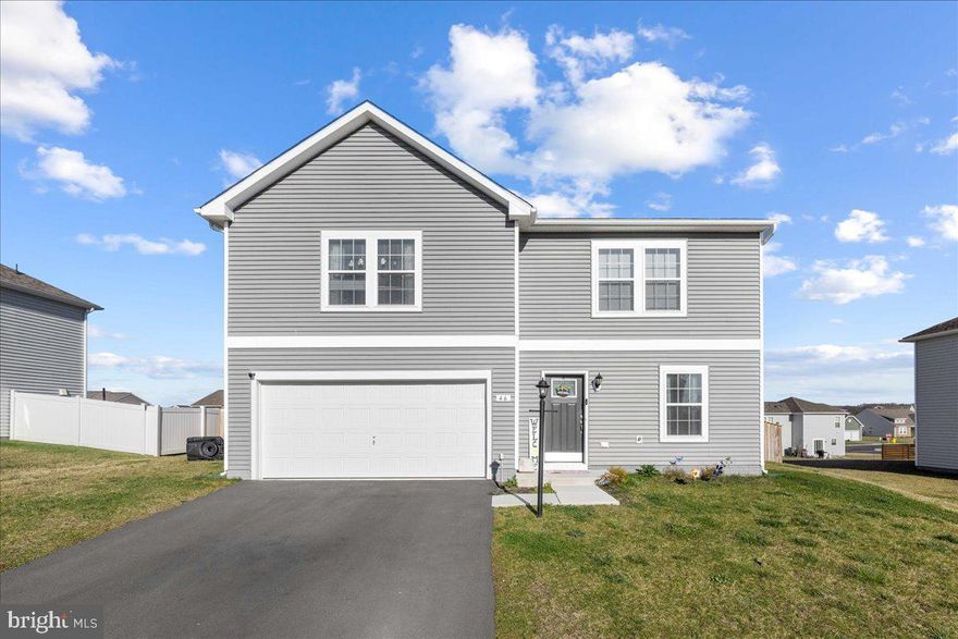 Welcome to your new home at Morning Dove Estates in picturesque Bunker Hill, WV. This stunning residence offers the perfect blend of modern comfort and timeless elegance. Boasting 4 bedrooms and 2.5 bathrooms, plus a versatile office space that could easily serve as a 5th bedroom, this home provides ample space for families of all sizes.  It also has around 1764 Square feet of living space! Step inside and be greeted by an inviting open floor plan that seamlessly connects the spacious living room to the kitchen. The kitchen is a chef's dream, featuring stainless steel appliances, an oversized island with room for bar stools, and a convenient pantry. Enjoy meals in the adjacent dining area, which offers easy access to the backyard through a sliding glass door. Outside, discover your own private oasis within the confines of a large fenced backyard, complete with a wooden privacy fence and a convenient gate for effortless access. Perfect for entertaining or simply unwinding after a long day, this outdoor space is sure to impress. Upstairs, retreat to the comfort of 4 well-appointed bedrooms and 2 full bathrooms, along with a convenient laundry room for added convenience. Take in breathtaking mountain views from the front of the home, providing a serene backdrop to your everyday life. The primary bedroom is large allowing plenty of room for a king sized bed and furniture, the bathroom suite attached is also impressive with a walk-in shower and closet.  Additional features include a 2-car garage for extra storage, a paved driveway, and the peace of mind that comes with owning a home built in 2021. Don't miss your chance to make this exceptional property your own – schedule a showing today!