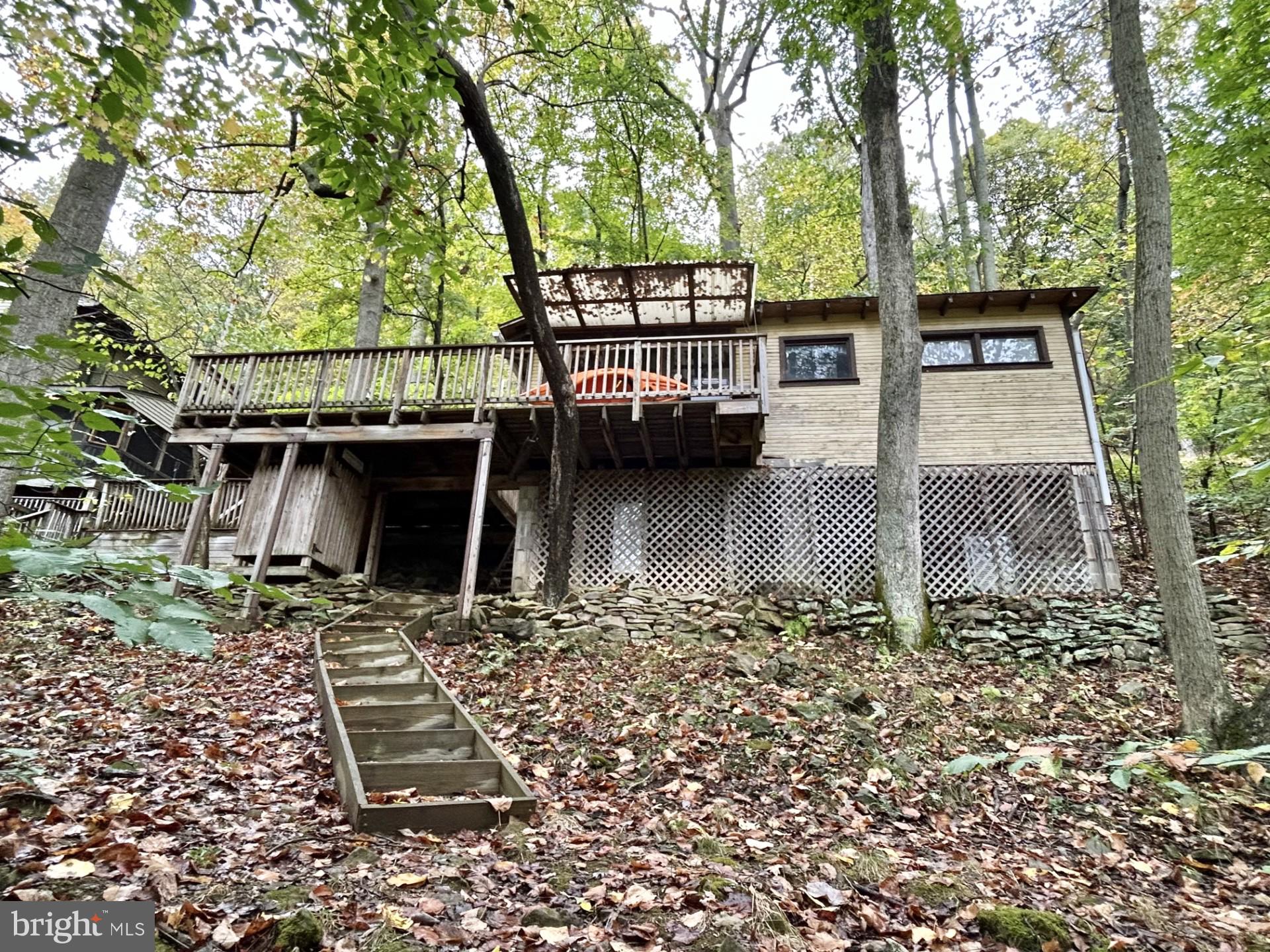 Ever dreamed of owning your own getaway on Yough Lake with your own personal boat dock and boat slip? (a very rare find in the area) - permit conveys as well. Here is your chance!! Secluded seasonal cabin which sits right on Yough Lake. Amazing relaxing oasis. Yet, not far from the hiking/biking trail, several fishing streams/rivers. Just a few miles from Ohiopyle, Nemacolin Resort, Seven Springs and Hidden Valley resorts. Not far from several golf courses, short drive to Deep Creek Lake area. The best of both worlds awaits!