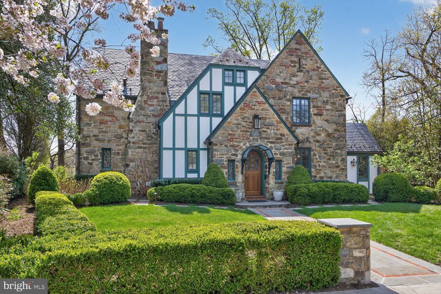Set on one of the most coveted cul de sac blocks in Massachusetts Avenue Heights, 2604 31st Street NW is an elegant stone Tudor with four bedrooms and four and a half baths, meticulously renovated to blend timeless architectural character with the finest modern systems and finishes on over 5,400 finished square feet (tax record). Custom carpentry throughout, including crown moldings, baseboards, and built-in details, honors the home’s Tudor roots at every turn.

The main level is organized around a gracious center hall. A formal living room with a fireplace and French doors sets the tone, while a generous dining room, lit by a custom chandelier, offers refined entertaining spaces. The chef’s kitchen features Calcutta solid marble countertops, a Lacanche range, Sub Zero refrigeration, a Wolf microwave drawer, a Shaws Original farmhouse sink, and custom cabinetry. An elegant library with custom paneling with a large bank of windows with tremendous treetop views. French doors open onto a bluestone terrace appointed with a built-in DCS gas grill, stone grilling island, and Bevolo coach lanterns to light up dinner parties.

The second floor offers three bedrooms, including the large primary suite with walk in claiset. The primary bath features heated Calcutta marble floors, a marble double vanity, a Bain Ultra soaking tub, and an exposed thermostatic shower system with Herbeau polished nickel faucets. A guest bath with marble floors, walls, and vanity top serves the additional bedrooms. The third floor provides a private fourth bedroom and full bath.

The expansive lower level features travertine floors and a beautiful arched door that opens to a bluestone terrace. A family room, second kitchen, full bathroom, and laundry room round out the space, with garage parking for multiple vehicles.

Notable systems include geothermal HVAC, Lutron lighting controls, slate roof with copper gutters, whole-house water filtration, and security system.

The Woodland Normanstone neighborhood offers a welcoming community, and the location is minutes from schools, the National Cathedral, Cleveland Park, Georgetown, Glover Park, and Dupont Circle.