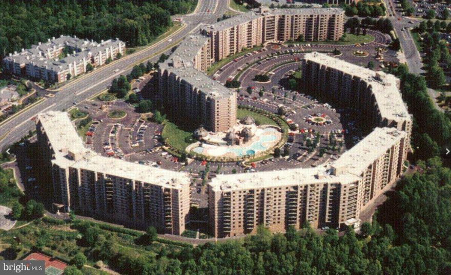 Rarely available.   With over 1800 sq ft , this corner unit has windows on 3 sides allowing the condo to be filled with natural light. Fresh paint throughout.  Featuring 3 large bedrooms, 2 full bathrooms and an updated kitchen.   This condo has a Sunroom AND an extra large balcony. The separate dining and living area provides a great flow for entertaining.  The Rotonda, a gated community in the heart of Tysons consists of 34 acres across the street from  The Boro's  Whole Foods,  movie theater,  restaurants and shops. Conveniently located  on the Silver Line metro  within walking distance of 2 stops.  With loads of  amenities including, indoor and outdoor pools, gym, tennis courts, pickle ball courts, playgrounds, BBQ areas, an enclosed dog park, and a putting green. Enjoy the Walking trails around the ponds.  Check out the  2 level Community Center to see  the gym,  library, multi purpose room,  and business center, as well as the indoor swimming pool.  The game room has billiards, ping pong, foosball and air hockey. There is a Do it your self car wash with vacuum.   Unit comes with 1 assigned garage parking space and 2 unassigned surface level parking spaces.  The country club feel makes this a great place to live.