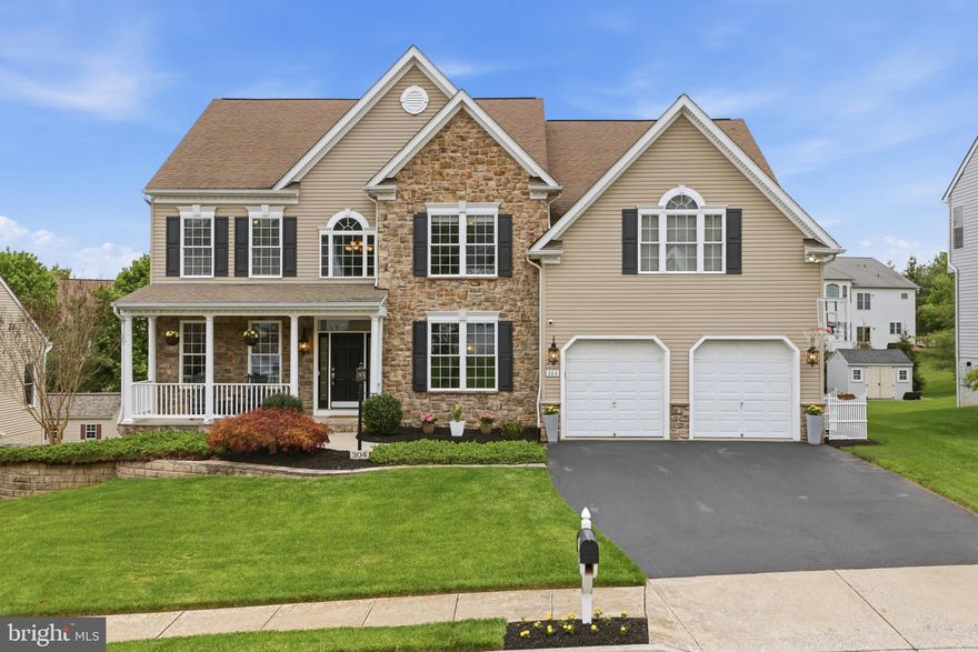 Set within the highly sought-after Sterling Glen community in Mount Airy, 304 Saddleback Trail presents an exquisite blend of timeless elegance and modern comfort, defined by exceptional craftsmanship and attention to detail.

From the moment you arrive, the home’s stunning curb appeal makes a lasting impression, with lush, professionally landscaped grounds, a distinguished stone-and-siding façade, and a charming covered front porch—perfect for morning coffee or unwinding in the evening.

Inside, a grand foyer with gleaming hardwood floors introduces an elegant curved staircase, setting a dramatic tone. The main level is anchored by a breathtaking two-story family room, where expansive Palladian windows flood the space with natural light, complemented by a striking stone gas fireplace and an open layout ideal for both everyday living and sophisticated entertaining.

The gourmet kitchen is a true centerpiece, thoughtfully designed with a large center island with seating, rich maple-toned cabinetry, granite countertops, stainless steel appliances, recessed lighting, a butler’s pantry with wine fridge, and a spacious walk-in pantry. The adjoining breakfast area flows seamlessly to a large rear deck with walk-down access, offering beautiful sunset views and a serene backyard setting.

Formal spaces include a grand dining room enhanced by chair rail and crown molding, along with a versatile private den or living room. Two well-appointed half baths complete the main level.

Upstairs, an open landing with recessed lighting and a balcony overlook creates an airy connection to the space below. The expansive primary suite serves as a luxurious retreat, featuring a tray ceiling, ceiling fan, generous walk-in closet, and a spa-inspired bath with dual vanities, a jetted soaking tub, and a separate shower. Secondary bedrooms are thoughtfully designed, including one with a private en-suite bath and two additional bedrooms connected by a Jack and Jill bath.

The finished walkout lower level expands the home’s living space with a generous recreation room with luxury vinyl plank flooring, highlighted by a wraparound wet bar—ideal for entertaining. This level also includes a fifth bedroom, a full bath, and a dedicated exercise room with mirrors and storage, offering exceptional flexibility.

A two-car attached garage completes the residence. Ideally positioned with convenient access to I-70, the home allows for easy commuting to Frederick, Baltimore, and the Washington, D.C. metro area, while remaining just minutes from Mount Airy Town Center for shopping, dining, and everyday conveniences.

This is luxury living at its finest—where elegance, space, and location come together in perfect harmony.