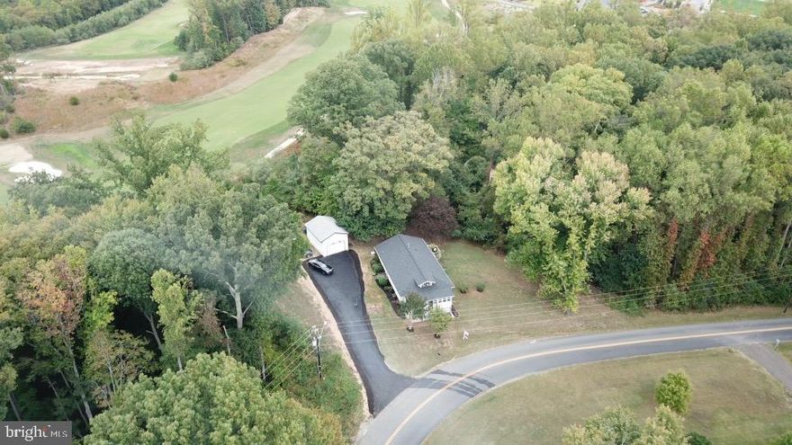 Tax Records say three bedrooms, but converted currently to two!  Recently renovated, it has incredible potential as an investment property or personal dwelling!  Move in ready, come enjoy the huge, open kitchen with gleaming new stainless steel appliances and dining area that leads to the deck through a sliding glass door.  Amazing brand new washer and dryer.  The spacious living room with recessed lighting leads to a super four season sun porch with windows all the way around and there is even a river view!  Many new renovations, including new roof, new flooring, updated baths and vanities, new well pump, vapor barrier under house, dehumidifier, and much more.  In a nod to the past, there is one original closet in the house that has the original door and know, as well as the original shelf paper.  A brand new paved driveway leads to the huge detached garage, which has one and a half stories, all new siding, full electric and lighting.  The first floor is big enough to hold a boat, engine lift, or big truck.  A ladder leads to private, screened and lockable storage on the top floor.  The almost an ACRE backs to an incredible Jack Nicklaus golf course and trees.  You won t be looking at neighbors!  This is the perfect location to enjoy quiet evenings after work or on weekends!  Located near shopping and amenities.  A new VRE station and Town Centre are going in at the end of Cherry Hill Road.    All systems were inspected in 2018 and subsequently many improvements, upgrades, repairs and replacements have been made.  House is in move in condition and ready for you to enjoy!