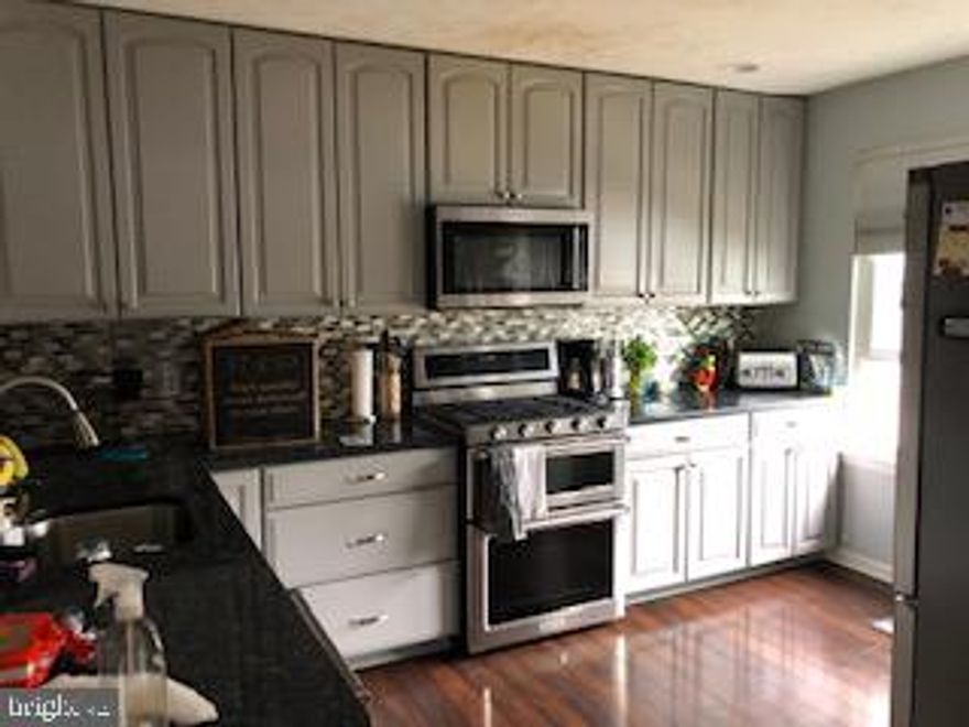 Beautiful town home comes all updated!  Two fire places,  ,Gourmet kitchen  with gorgeous appliances ,Granite countertops, Beautiful cabinetry,  washer and dryer, fenced in back yard ,this home has 2 bedrooms upstairs and a third in the Finished lower level , 2.5 Baths  comes complete with 2 assigned parking spaces.