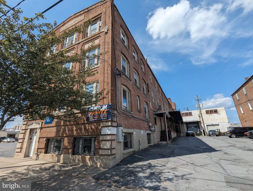 Previous bakery space with hood vent area and open layout, with private office. No Kitchen equipment included.  Ideal for similar use or flexible commercial space.  There are shared hallway restrooms and shared on site parking. This space is on main level with half flight of stairs to main entrance, stairs only no elevator. Mixed-use property with flexible zoning permitting a range of uses. Additional space available for lease on same property. See brochure in documents.
Also available:
+/- 2,100 SF auto shop available
Industrial loft style flex suite 3,500 SF- Ideal for group classes or fitness
1,680-11,400 SF of Industrial Space with 4 docks