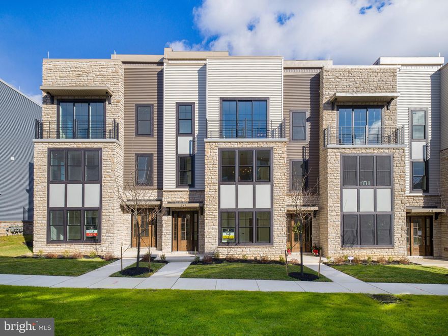 Experience the epitome of modern living in this exceptional end townhome that is move in ready! This is your chance to treat yourself to the ultimate gift this year – a pristine, low-maintenance, brand-new home.

Nestled in the sought-after community of The Towns at Newtown Walk, you'll find convenience at your doorstep. Imagine strolling to Whole Foods, grabbing a quick bite at local coffee shops or Wawa, savoring delectable meals at nearby restaurants, staying fit at local fitness centers, and exploring various shops – all within walking distance.

This vibrant new construction community boasts a unique floor plan that has won the hearts of our homeowners. As you step into the welcoming foyer on the first level, you'll immediately notice the convenience of a 4-stop ELEVATOR, a coat closet, a versatile guest bedroom or office space, and a full bathroom. The rear 2-car garage and spacious 2-car driveway provide ample parking for you and your guests.

Moving up to the main living level, prepare to be captivated by the soaring 10-foot ceilings and the inviting open concept layout. The kitchen takes center stage with its 42" soft-close cabinets, exquisite quartz countertops, expansive island, stainless steel appliances, and gleaming hardwood floors. Hosting gatherings is a breeze in the stylish dining area, and you'll relish leisurely evenings in the generous living space complete with a gas fireplace.

The primary bedroom easily accommodates a king-sized bed, large dresser, and nightstands, and the massive walk-in closet offers plenty of space for your clothing and shoe collection. Unwind in the ensuite bathroom featuring a walk-in shower with a bench, a private water closet, and a double vanity.

A hallway with laundry facilities and a linen closet leads you to the second guest suite bedroom, complete with its own bathroom and walk-in closet.

But the true highlight of this exceptional home is the rooftop terrace, providing an abundance of outdoor space. Picture yourself sipping your morning coffee as the sun rises or enjoying an al fresco dinner with loved ones. This space even allows for planter gardening and offers the option for a fireplace or BBQ area.

The Towns at Newtown Walk is your final opportunity to be part of the thriving Ellis Preserve community. With easy access to major roadways, the airport, the train station, and Routes 252 and 3, your commute is a breeze.

Please note that actual home finishes may vary.  We invite you to tour the floor plan and preview the finishes in our look book photos. Don't miss out on the chance to make this exceptional modern townhome your new sanctuary!