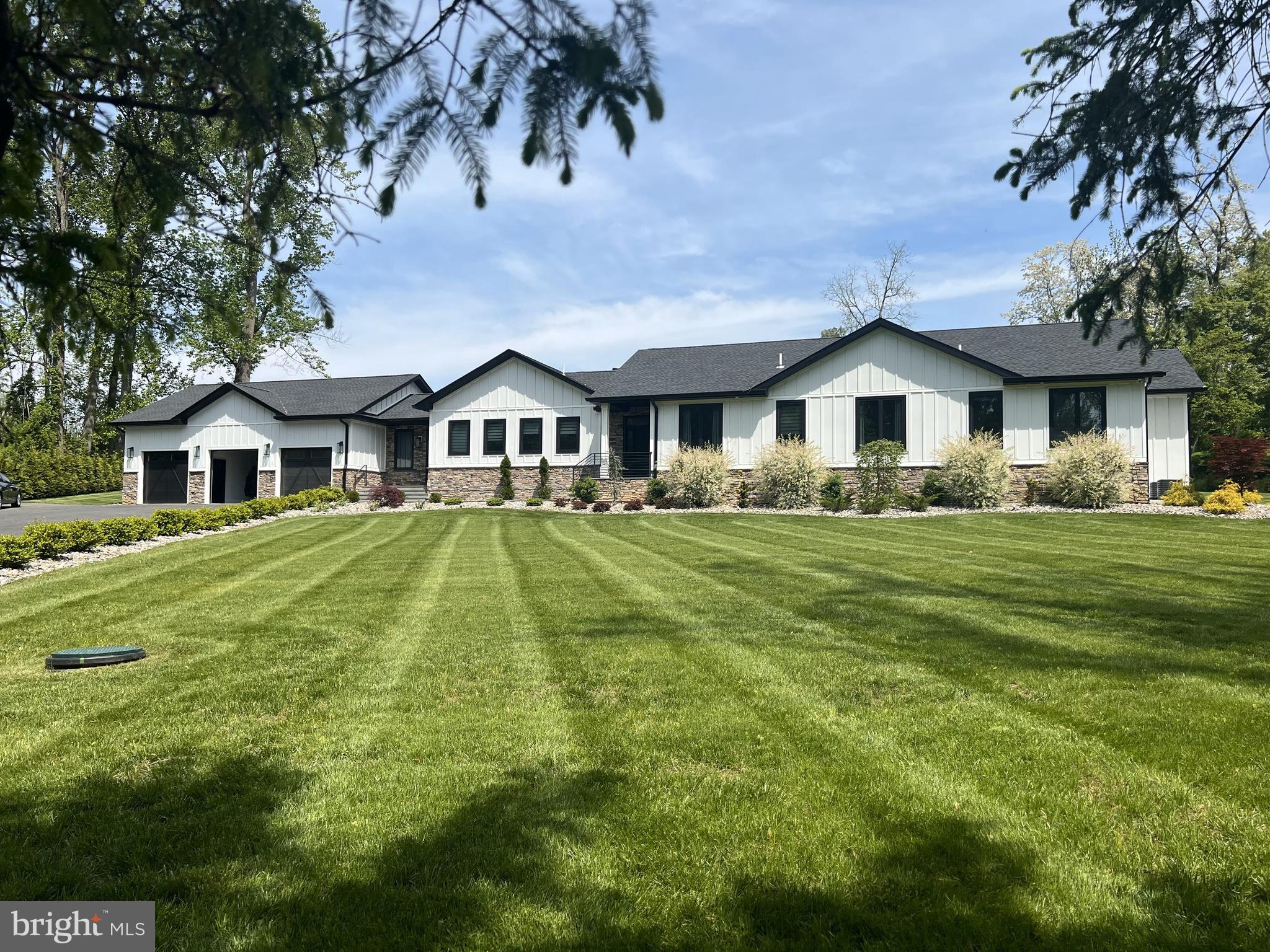 Superior craftsmanship abounds in this spectacular custom home built on nearly 2 acres. This expansive ranch style home showcases the finest of materials and upgrades including 10 ft. ceilings, heated hardwood floors, 2-zone heating/cooling, instant hot water, Renewal Fibertex Andersen windows, Hardi Plank siding, Nest thermostats, recessed lighting, whole house sound system, spray foam insulation and sound proof walls. An inviting foyer greets you upon entry leading to the center of the home, a stunning dining room featuring an oversized double set of sliding doors allowing for a beautiful, unobstructed view of the private and serene backyard. A second, more informal entry includes a spacious mud room with built-in cubbies and access to a finished 3-car garage. The true heart of the home is the kitchen, a pristine blend of elegance, style and functionality- floor to ceiling cabinets, granite countertops, Monogram appliances, and a massive island with seating and stove-top cooking. A wine fridge and separate ice maker complete this gourmet domain. Lending to an open floorplan and adjacent to the kitchen is a large, light-filled family room with a striking wood-burning fireplace as the centerpiece. This roomy yet cozy space allows for seamless entertaining or simply, a place to relax and unwind. The far end of the home provides a luxurious retreat comprised of 4 large bedrooms. The master includes a sizeable walk-in closet and an ensuite complete with double vanity, lighted non-fog mirror, heated floors, rainfall shower and a separate soaking tub. A second bedroom also includes an ensuite while the 3rd and 4th bedrooms have a Jack-n-Jill style shared bathroom. The thoughtful outdoor design matches the opulence of the home's interior. This tranquil oasis is equally ideal for relaxation or hosting a fantastic gathering. A sprawling flagstone patio connects to an incredible roof-covered outdoor kitchen area complete with a seated bar, built-in grill, refrigerator, hibachi and double kegerator. An outdoor speaker system tops it all off for an amazing entertaining space. LED lighting and stone landscaping enhance the elegance of the home while a drip irrigation system makes keeping the grass green and plantings watered a breeze. Additionally, all gutters are connected to a stormwater management system keeping both the home and property dry. The property backs to preserved land and is in close proximity to award winning Garnet Valley schools as well as the Wawa Station SEPTA stop. This stunning, one-of-a-kind home is truly exceptional and not to be missed.