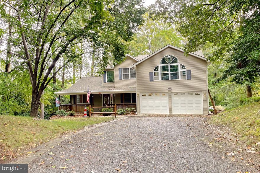 Well crafted custom-built colonial home nestled on a serene .5790-acre cul-de-sac lot with Chesapeake Bay Access. ​ Built in 1997, this SMECO-certified energy-efficient property offers approximately 3,800 square feet of living space, modern updates, and access to two private beaches on the Chesapeake Bay. ​ Key Features: Elegant Design: Two-story Colonial style with vinyl siding, vaulted ceilings, skylights, and arched windows for abundant natural light.  First Floor: Tile and hardwood floors, a spacious living room with a stone propane fireplace, formal dining room with crown molding, a den with French doors, two vaulted decks, a custom sunroom, and an updated kitchen with granite countertops, stainless steel appliances, and a breakfast nook. ​ Second Floor: Luxurious master suite with vaulted ceilings, a walk-in closet, and a spa-like tiled bathroom featuring a soaking tub and glass shower. ​ Two additional bedrooms, a second full bathroom, and versatile spaces for an office or study. ​ Newly recarpeted in 2023. ​Finished Basement: Includes two bedrooms, a large living area, kitchen, walk-in closets, and a decked patio. ​ This area could be an in-law or other family member living area. OR....Maybe a rental and income potential. There is a set up even if desired to have a home business of a beauty or barber shop. Just so much flexibility for you.  Lowest level also features a humidity-controlled safe room for secure storage. ​Outdoor Living: Covered front porch, landscaped grounds with rhododendrons, hollies, azaleas, and camellias, and a detached electrified storage shed. ​Garage: Finished double garage with A/C, workbenches, and built-in cabinets. ​This home offers the perfect blend of comfort, style, and functionality, with modern updates like newly installed 6" gutters and downspouts. ​ Enjoy the tranquility of wooded surroundings while being just steps away from the Chesapeake Bay. ​ Schedule today to  plan your Holiday Season in your own home!