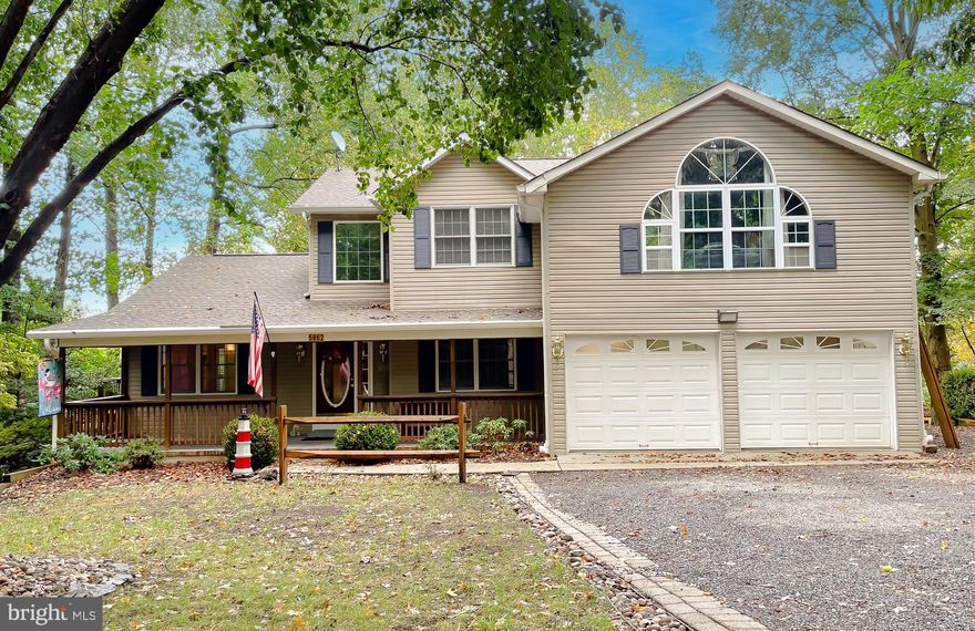 Welcome to a well crafted custom-built Colonial home nestled on a serene .5790-acre cul-de-sac lot with Chesapeake Bay Access. ​ Built in 1997, this SMECO-certified energy-efficient property offers approximately 3,800 square feet of living space, modern updates, and access to two private beaches on the Chesapeake Bay. ​ Key Features: Elegant Design: Two-story Colonial style with vinyl siding, vaulted ceilings, skylights, and arched windows for abundant natural light.  First Floor: Tile and hardwood floors, a spacious living room with a stone propane fireplace, formal dining room with crown molding, a den with French doors, two vaulted decks, a custom sunroom, and an updated kitchen with granite countertops, stainless steel appliances, and a breakfast nook. ​ Second Floor: Luxurious master suite with vaulted ceilings, a walk-in closet, and a spa-like tiled bathroom featuring a soaking tub and glass shower. ​ Two additional bedrooms, a second full bathroom, and versatile spaces for an office or study. ​ Newly recarpeted in 2023. ​Finished Basement: Includes two bedrooms, a large living area, kitchen, walk-in closets, and a decked patio. ​ This area could be an in-law or other family member living area. OR....Maybe a rental and income potential. There is a set up even if desired to have a home business of a beauty or barber shop. Just so much flexibility for you.  Lowest level also features a humidity-controlled safe room for secure storage. ​Outdoor Living: Covered front porch, landscaped grounds with rhododendrons, hollies, azaleas, and camellias, and a detached electrified storage shed. ​Garage: Finished double garage with A/C, workbenches, and built-in cabinets. ​This home offers the perfect blend of comfort, style, and functionality, with modern updates like newly installed 6" gutters and downspouts. ​ Enjoy the tranquility of wooded surroundings while being just steps away from the Chesapeake Bay. ​ Schedule today to  plan your Holiday Season in your own home!