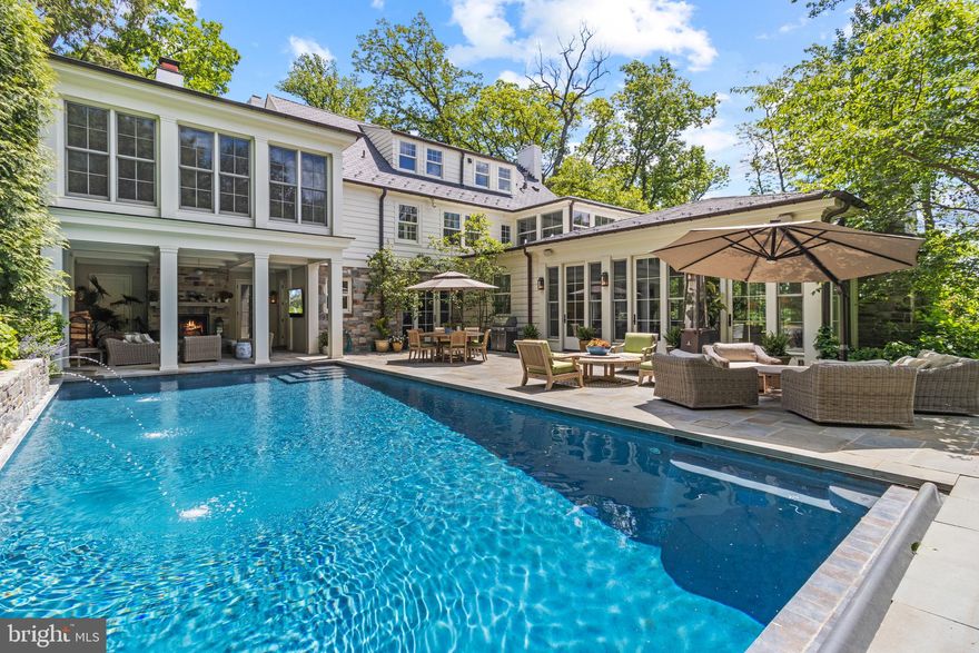 Just listed in Wesley Heights! Discretely positioned above one of Washington’s most prestigious streets, this exceptional residence boasts approximately 6320 sq feet of completely renovated world class living on four levels. The peaceful setting of this home next to Battery Kemble Park coupled with sculpted landscaping, and sunset views will take your breath away. Renovated in 2014 by architect Dale Overmyer, this magnificent property offers extraordinary scale and exceptional privacy. The main level entry space includes thoughtful sight-line views to the parkland behind the residence. There is a gracious eat-in kitchen/family room with 15-foot ceilings and 3 sets of French doors that provide the room with spectacular natural light. The first floor also includes a cozy library, lovely dining room, spacious living room, laundry room and pool cabana. Brilliant light, scale and impressive details are found throughout the entire residence. The Second level includes a generous master suite with dual dressing rooms, a second laundry area,  stunning bathroom, and magnificent sun drench bedroom with remarkable views all the way across the river.  The lower level includes a large recreation room, nanny suite with full bathroom, large gym, and 3rd laundry area. The grounds include and indoor-outdoor poolside living area with fireplace, incredible mature gardens, heated saltwater pool, a sport court, multiple terraces for outdoor dining and entertaining. Showings by appointment.