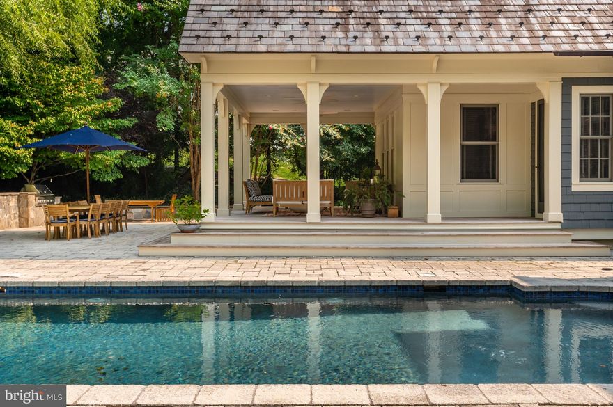 Presenting Manderly, spectacular custom design by Rob Morris, a renowned architect and designer who was known for incredible attention to timelessness detail. Enjoy the winding cherry tree lined drive to the charming cobblestone courtyard entrance. One-of-a-kind custom Stone English Manor covered in meticulously manicured ivy surrounded by mature landscaping and trees on a private 2 acre lot with a separate 100 year old renovated Guest Cottage. The entrance vestibule is an old English style hall that opens to the 18 foot tall Great Room with soaring windows, coffered ceilings, massive fireplace with a mantle that supported by carved wood griffins and three balconies that project prominently into the Great Room giving presence to the tall space. The ironwork and lighting fixtures, many retrieved from centuries old manor houses adds old world sophistication. Wide plank floors circulate throughout and achieve a rustic yet refined look. The Dining Room has deeply vaulted ceilings, French doors and a Butler’s Pantry complete with a kitchenette. Custom gourmet Kitchen features top-of-the-line appliances, stainless steel counter tops and a center island with custom wood cabinetry. Off the Kitchen is the cozy Family Room and Breakfast Room. Continuing on the Main Level is a Powder Room with Chalkboard Painted walls, a sumptuous Office/ Study and the Owner’s Suite that opens to a porch for easy access to the pool. An unmatched, two level owner’s Bath has steps down from the vanity area to the spa like bathing area with a sunken tub and open shower, truly dream-worthy! The Upper Level boasts 4 spacious Bedrooms and the Lower Level is a retreat complete with a Recreation Room, Media Room, Bedroom with Full Bath and a Multipurpose Room. The truly amazing and serene park-like grounds offer a sparkling Pool with and overflow feature, Patio and covered porch for entertaining, built in grill for summer cooking and a charming Guest Cottage with a Kitchen, Dining Room, Office, Living Room and two private Bedrooms. Unbeatable location, only minutes to DC, Tyson, National Airport and world-class shopping and dining!