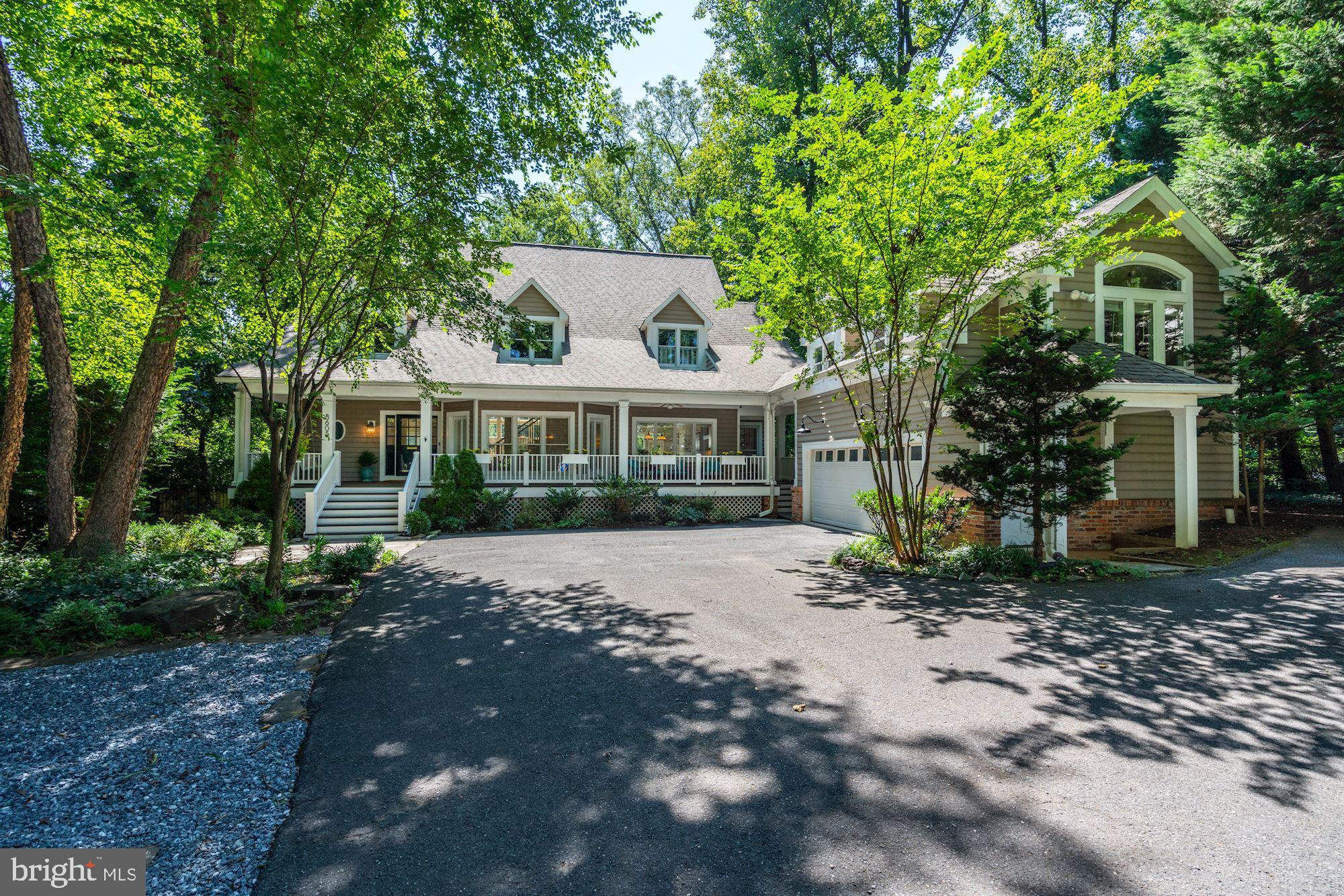 This sun-filled, six-bedroom home includes a separate accessory unit and is ideally situated on an expansive, professionally landscaped 30,000+ square foot lot on a cul-de-sac in the desirable Hillmead neighborhood. The charming front porch and private back deck compliment the beautiful interior, with stunning features including hardwood floors and oversized windows throughout. The main level boasts a spacious and open floor plan with an elegant formal dining room, grand two-story formal living room with floor-to-ceiling windows, French doors leading to the deck, and a double-sided gas fireplace to the family room. The main level continues with a private library with built-in bookshelves, powder bath with the option to be converted to a full bath, and gracious foyer with brick pavers. The gourmet eat-in kitchen has been beautifully updated, complete with Viking stainless steel appliances, marble countertops, ample cabinetry, a center island with seating, and a breakfast nook, which is open to the inviting family room with a gas fireplace and built-ins. The second level features three bedrooms and two full baths, including the primary suite with a gas fireplace, a Juliet balcony with views of the private backyard, custom walk-in closets, and an oversized ensuite bath with separate sinks, a soaking tub, walk-in shower, and water closet. The large primary walk-in closet can be converted to an additional bedroom or laundry room, as it is already equipped with laundry hook-ups. The sizable walk-out lower level is complete with a recreation room, kitchenette, two additional bedrooms with a full bathroom (perfect for an in-law or au pair), laundry, and ample storage. The ultra private, tree-lined rear exterior serves as an extension of the home including the back deck, covered patio, and an expansive, flat, fully fenced-in and professionally landscaped yard, complete with a trampoline. A large detached garage with an accessory unit above with kitchenette, full-bath, and separate laundry, makes for an ideal guest suite or studio. Set back from the cul-de-sac, the long driveway with additional parking completes this home. Located in Hillmead, this home is walking distance to restaurants, shops, Hillmead Park, as well as in close proximity to downtown Bethesda, metro, and major commuter routes.