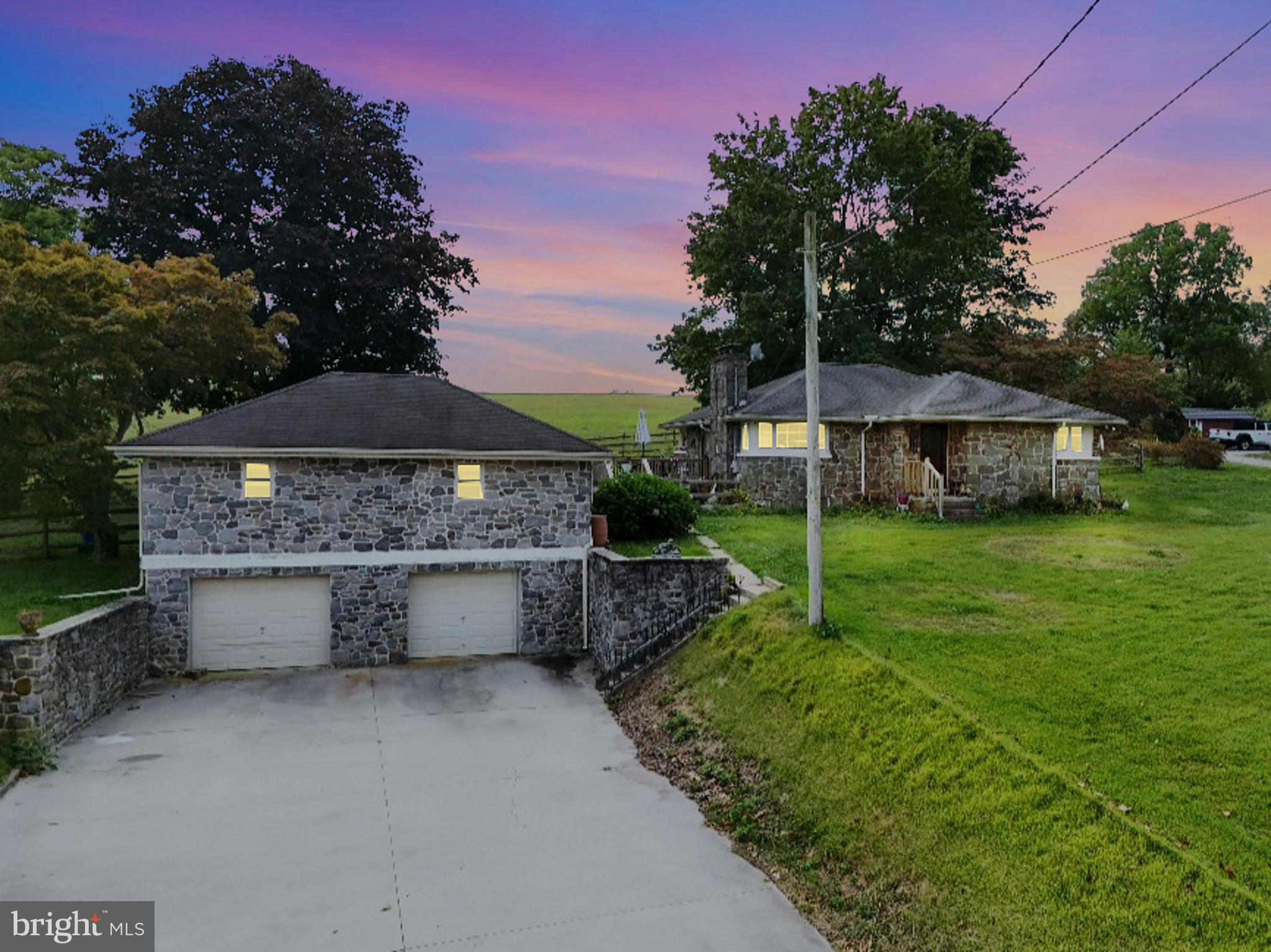 Charming Stone Ranch with Scenic Country Views! Nestled on a spacious .60-acre lot between Spring Grove and Hanover, this home offers timeless features including a cozy brick fireplace, hardwood floors, cedar-lined closets, and knotty pine walls that bring warmth and character. The full basement includes a second full bath, offering flexibility for additional living space or storage. Outside, the large fenced yard is perfect for pets, gardening, or gatherings. A paved driveway leads to the two-car detached garage with a generous workshop and storage area above—an ideal setup for hobbyists or collectors. With a few personal touches, this property is ready to shine and become your own.