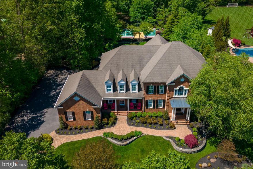 Interior pictures soon to follow!

Entertainers delight and a rare offering on one of the most beautiful streets in  Annapolis! An intimate neighbourhood of large homes with acreage close to horse stables and walking distance to blue ribbon Broadneck schools, walking paths, shops and Broadneck Park.  Incredibly private yet minutes to all the attractions of Annapolis. 1318 Windsor Ridge Lane is a spacious elegant home situated on almost 1.5 acres of extensively landscaped park like grounds ,including a lighted sports court for tennis/pickle ball and basketball!  About 1700 s/f of outdoor terrace including a swim spa and generous entertaining terrace.

This  extremely well designed and well built home by Koch builders has exceptional features both inside and out totalling over $650,000 in upgrades.  Over 7000 s/f of living space with solid  hardwood floors throughout.  6 generous en-suite bedrooms , expansive master bedroom suite with tray ceilings, large sitting area, generous walk-in closet, and spacious master bathroom.   Great sunroom, hardwood floors on main and second floor, perfect gourmet chef  kitchen with huge island,  GE Monogram 6 burner range, 2 ovens, an Advantium oven/microwave,  2 dishwashers ,warming drawer, and all stainless steal appliances.
Special features include : walkout basement with full entertaining area ,a projector television with sound system built in, pool/game room  along  with a  full kitchen, granite bar next to the double French doors going out to the garden, recently installed dance studio with special dance floor and mirrored wall, ballet bar that can be used as a yoga studio or exercise room, three generous storage areas.  Outside features include: sports court, swim pool /spa with light year around cover,  gorgeous hardscape, spacious dry storage under deck  with electricity for equipment and storage, 18 zone irrigation system, landscape lighting, fully enclosed yard with invisible fence, upgraded security system, generator, large decks, 3 car garage.  For anyone requiring more, there are plans for custom pool that can be easily added to the backyard.  Freshly painted and updated in the last year ,brand new air conditioner in 2021 servicing the upper level 4 en-suite bedrooms with UV air sanitizer.  This home is a rare gem and perfect for all ages providing countless hours of fun and entertaining!