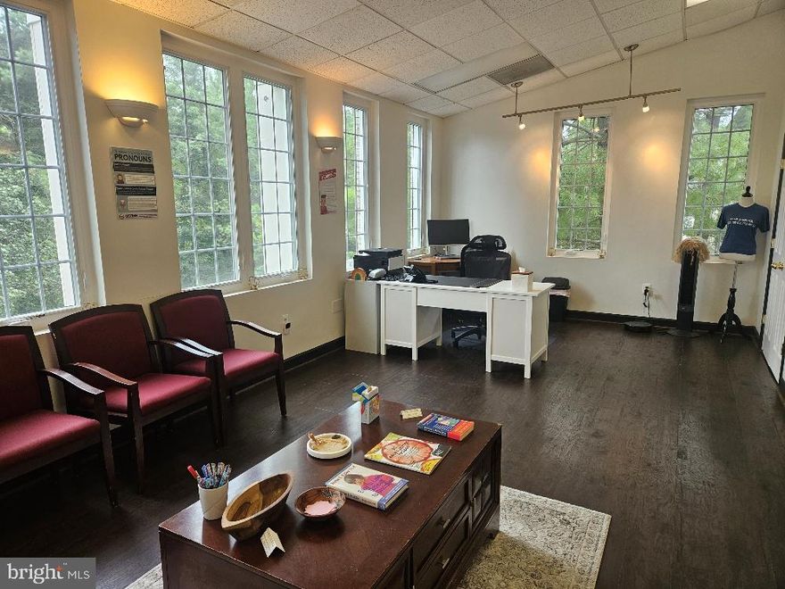 Lovely, bright & sunny upper end unit with the high ceilings and great window-line for lots of natural light!  Efficient layout has large room for group meeting/admin/workspace, 4 private windowed offices, kitchenette, restroom & utility closet.  Unit was renovated and redecorated in 2023 and has new LVP (vinyl plank) flooring and windows.   Plenty of unassigned parking, uniform exterior signage allowed, and 24/7 access.  Owner currently occupies, and unit will be available for occupancy November 1st.  Existing furniture and equipment is available to remain and convey for Tenant's use (optional).  Please call agent ahead of going to schedule showing and for door combo.