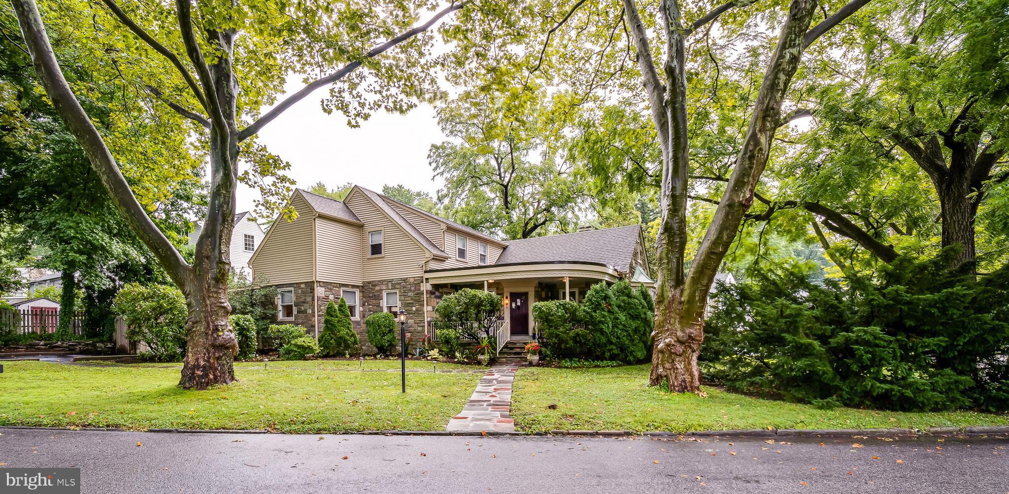 Abundantly charming with tremendous original character, this beautiful home has been enhanced and elevated via thoughtful, expertly executed attention to detail. This gorgeous Wynnewood stunner is simply turn-key and move-in ready. Perched on a spacious corner parcel, with mature, statuesque trees aligning leafy Witley, 401 makes a commanding statement. This property is special. As you walk up the flagstone pavers to the front door, you are greeted by a welcoming wrap porch that beckons you to sit and enjoy an icy glass of lemonade. Enter into the bright and airy foyer graced by a beautiful arch and an abundance of natural light. Note the peaceful silence. The expansive main live space features a cozy wood-burning fireplace, and is lined with windows framing peaks of the greenery beyond. Lovely original oak flooring with ribbon border, custom and recessed lighting, fresh paint throughout, and new designer doors and window treatments. Grand dining room, ideal for large gatherings and entertaining, boasts a large picture window. The gourmet kitchen is compact but packs a powerful punch, with granite countertops and island, stainless appliances, built-in wine rack, elegant pendant lighting, custom cabinetry and backsplash, and a honed marble floor. Adjacent to the kitchen sits a rustic little seating nook, perfect for morning coffee and newspaper or a working lunch. Step outside onto a lovely, private and spacious flagstone pavered patio, perfectly situated for outdoor dining under the stars, enjoying a sunny afternoon with a great book, and expansive open air mobile work space. There is convenient access to the amazing 1.5 car garage with new door, fitted with incredible, organized storage and lots of space for bikes, lawn equipment and all the "stuff" that belongs in a proper garage. Let us step back inside and continue our progress through the amazing first floor of this very special home. A welcomed rarity, 401 provides the flexibility to use the spacious first floor bedroom as a master suite, guest bedroom, or au pair quarters. Tucked away in the ideal first floor corner, this suite is extremely private and boasts large windows, ample closet space, and en suite full bath. Nestled adjacent to this first floor suite, a second large room serves as a comfortable home office, library or den. A convenient powder room chock full of original character completes the first floor. A short flight upstairs, to the left, enter into the main bedroom suite. Extremely spacious and light-filled, this graceful space is flanked with windows and is roomy enough for a seating area. Fabulous main closet is cedar with two supplementary cedar closets, and a recently renovated bath with granite-topped vanity and pebble-floored walk-in shower. The home's second floor boasts two additional bedrooms, both of which are bright and airy, provide plentiful closets, and have unique character Gorgeous original hardwood flooring throughout. The third bedroom leads to a same-level floored attic space which creates exceptional storage and potential future opportunity to expand. A stunning, fully renovated marble hall bath completes the second floor. Perhaps the most wonderful surprise and best kept secret this incredible property holds is revealed when you stroll down a short flight of stairs from the home's first floor center hall to find a fully finished, 1,200 s.f. entertainment haven. This lower level adds myriad vignettes of priceless flex space. A cool bar is crafted of antique barnboards and jelly jar lighting fixture. Expansive room for movie night, a game of billiards, yoga, and a home gym. The laundry suite is bright and open with new counters, cabinetry and a stainless sink. A separate crafts room is ideal for a dedicated hobby or collection, play area or home library. There are several smaller chambers for additional storage, and a convenient half bath. Truly remarkable square footage, beautiful yet functional in ever