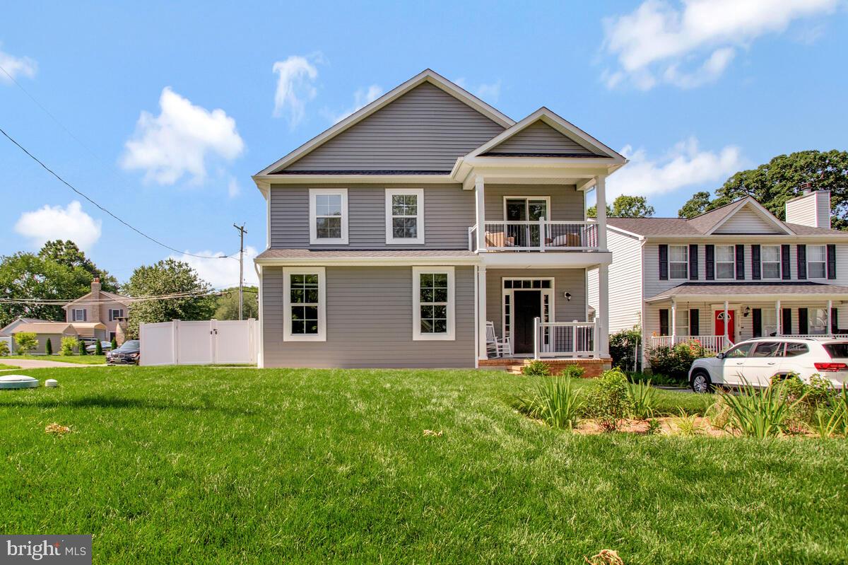 HUGE price drop!! This home was just built in 2024!! Beautifully crafted 4-bedroom, 2.5-bath home combining modern design with relaxed coastal charm just three blocks from the Chesapeake Bay. An inviting front porch welcomes you into a bright, open layout featuring wood floors, a cozy fireplace, and a spacious living area that flows seamlessly into the heart of the home—a stylish kitchen with quartz countertops, stainless steel appliances, and a large central island with seating, perfect for casual meals or entertaining. The primary suite offers a private retreat with its own balcony and a spa-like bathroom featuring a sleek walk-in shower. Three additional bedrooms provide flexibility for family, guests, or a home office. Enjoy outdoor living in the fully fenced backyard—ideal for gatherings, pets, or play. The attached two-car garage adds convenience and extra storage. Located minutes from Beverly Triton Beach, a dog-friendly spot with swimming and bathhouses, and Mayo Beach Park for more outdoor adventure. Just three blocks to Beverly Playground and shoreline access. Situated in the charming and historic coastal town of Edgewater, you’re close to local shops, dining, and the best of Chesapeake Bay living. This is more than a home—it’s a lifestyle.