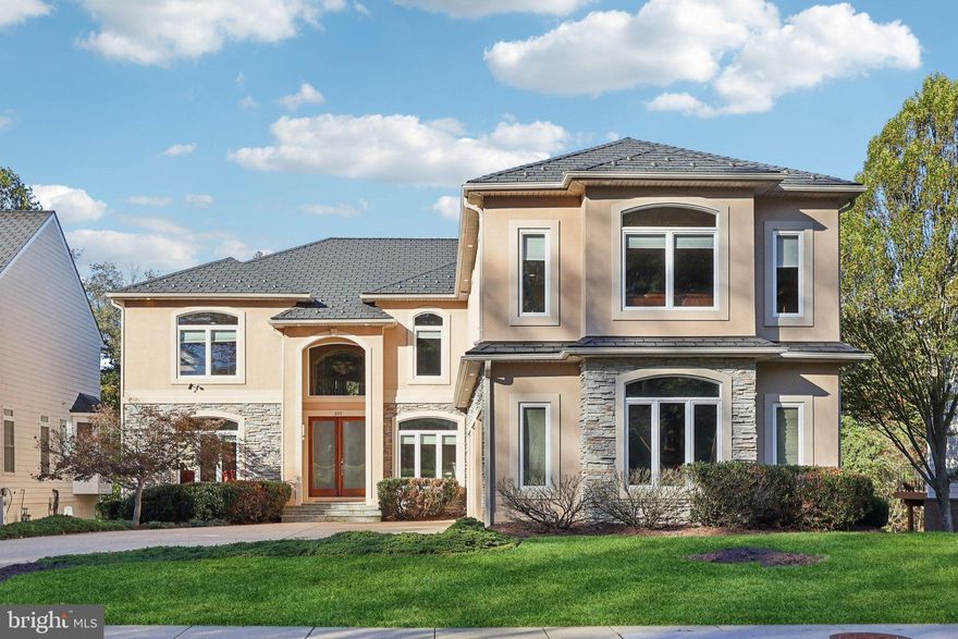 Welcome to 3211 Courtside Road, a Lakefront extraordinary custom residence in the prestigious gated golf course community of The Country Club at Woodmore. Offering over 7,800 square feet of luxury living, this 5-bedroom, 6.5-bath home perfectly blends traditional architecture with a modern, contemporary flair all with a view of the lake. Designed for comfort, entertaining, and multi-generational living, this home captures both elegance and practicality.  Step into a dramatic two-story foyer with gleaming solid hardwood floors and 2 marble inlays. Soaring ceilings, abundant natural light, and a seamless open layout make an immediate impression. The main level features formal dining rooms, a private office with French doors, bedroom with full bath, and a spacious family room accented by one of three dual-sided fireplaces.  A main-level bedroom with a private full bath offers flexibility for guests, in-laws, or extended family. An elevator provides convenient access to all levels, enhancing accessibility and ease of living.  The gourmet kitchen serves as the heart of the home, appointed with upgraded stainless steel appliances to include a Thermador six-burner gas cooktop, 2 double wall ovens, and 2 dishwashers. Rich cherry cabinetry, granite countertops, and an expansive island provide the perfect setting for gatherings. The adjoining breakfast area opens to a magnificent 60-foot wide rear deck overlooking serene lake and wooded views—ideal for outdoor dining and relaxation.  Upstairs, the primary suite is a true retreat—spacious and sun-filled, featuring a private sitting area, a private balcony with lake views, and a dual-sided fireplace shared with the luxurious primary bathroom. The ensuite bath includes dual vanities, a jetted soaking tub, and a walk-in shower, creating a spa-like experience at home. Also featured is 2 walk-in closets with custom cabinetry.  Each of the additional bedrooms offers its own private full bath, ensuring every family member or guest enjoys comfort and privacy.  The fully finished lower level extends the living space and with a spacious recreation room, full bar, theater room, and game room.  A whole-house sound system provides entertainment and ambiance throughout the home. The residence also includes a 24kW whole-house generator, ensuring uninterrupted power and peace of mind.  This home has been meticulously maintained and thoughtfully updated with a new 50-year roof, new HVAC systems, new generator, central vacuum, and new expansive deck with complete lake front views. The oversized three-car garage offers ample storage and workspace. An added bonus, no more cutting grass or shoveling snow, the HOA fee includes all exterior yard maintenance, front and back, and snow removal for the driveway and front porch.  Located within Woodmore, one of Prince George’s County’s most sought-after communities, residents enjoy 24-hour gated security and membership opportunities at the Country Club at Woodmore, featuring an Arnold Palmer-designed championship golf course, tennis courts, swimming pool, and a distinguished clubhouse offering fine dining and social events. The neighborhood’s manicured landscapes, lakes, and walking trails create a private, resort-style environment just minutes from Washington, D.C., Annapolis, and major commuter routes.  Schedule your private showing today.