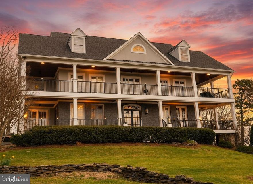Perched atop scenic Bull Run Mountain, this distinguished Southern Colonial commands 10 acres in the sought-after Haymarket countryside. With five bedrooms and four and a half bathrooms, this exceptional estate seamlessly blends refined architectural elegance with the tranquility of its natural surroundings. A stately wraparound porch encircles the home, offering uninterrupted, panoramic views - an idyllic setting for both intimate moments and grand entertaining. Inside, the residence reveals graciously scaled living spaces defined by classical millwork, soaring ceilings, and abundant natural light. Formal living and dining rooms provide an elegant backdrop for entertaining, while the gourmet kitchen serves as the heart of the home, designed to accommodate both everyday living and sophisticated gatherings. The upper level features generously appointed bedrooms, including a serene primary suite with sweeping mountain vistas. Each space has been thoughtfully designed to balance luxury and comfort. Beyond the residence, the grounds unfold into a beautifully maintained private vineyard, offering the rare opportunity to cultivate a personal wine estate or simply enjoy the beauty and heritage of Virginia wine country. A custom wine cellar and wine making room are conveniently located in the lower level of the home. A detached 4-car garage and large driveway provide ample parking for family and guests. Located just minutes from the charming towns of Haymarket and Middleburg, close to major thoroughfares, this property offers the perfect balance of seclusion and accessibility. Distinguished by its setting, scale, and timeless appeal, this is a truly extraordinary offering in Northern Virginia’s most picturesque landscape.