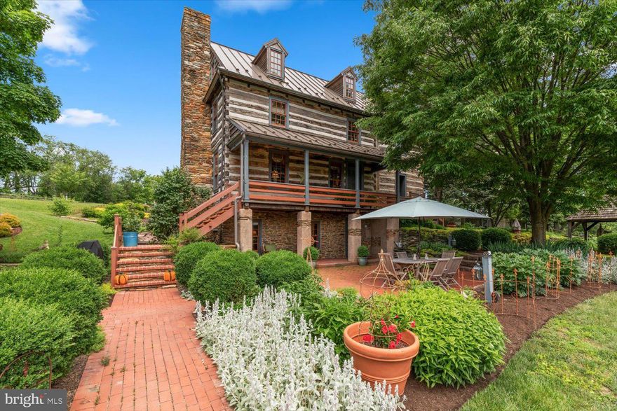 If you’ve been looking for a unique one-of-a-kind home with unmatched modern luxury and charm, and sitting on top of 10 acres of scenic Lancaster County farmland views, then stop your search - you’ve found home! Welcome to 3646 Meadow View Road in Manheim. A truly breathtaking Log Home that has been beautifully and thoughtfully renovated inside and out. The original home was built in 1800 at a different site, but was re-built at the present location in the 1990s on a modern foundation. Since then, the current owners have made some incredible upgrades and improvements during their ownership, including purchasing an adjacent parcel of land to increase the total acreage, qualifying for significantly lower taxes in the Clean and Green program, rebuilding the entire 3rd level (adding 2 bedrooms and a full bathroom), completely renovating the main-level kitchen with high-end Viking appliances and custom inset cabinetry, soundproofing the basement family room and 2nd kitchen, adding a sweeping rear screened-in porch (which could be finished for additional space in the future), installing an absolutely stunning multi-level Koi pond complete with relaxing and beautiful waterfalls, and so much more! There’s no shortage of attention to detail inside this beautiful home and from the moment you step inside, you’ll see the charm and preserved character that only a home of this caliber can showcase. The main level features a beautiful entry foyer, spacious living room with wood-burning fireplace, a dining area and the adjacent thoughtfully renovated kitchen space mentioned earlier. You’ll also find a huge screened-in porch off the rear of the home on the main level, which could easily be finished for additional living space, though you may find it a great way to relax and enjoy the sights and sounds of your property and the nearby Koi Pond. Going up to the 2nd level, you'll find the Primary Suite complete with bedroom and full bath with walk-in shower. The Primary Suite also features built-in closets with a sitting area and a wood-burning fireplace for those cozy nights or for a little ambiance. Additionally on this level you’ll find another spacious bedroom suite complete with its own full bathroom. On the 3rd level, the current owners completely renovated and structurally improved this space, adding 2 additional bedrooms and a full bathroom with claw tub and shower. The finished basement has its own unique charm, but has been brought into the modern world. A separate walk-out entrance to the basement level could allow for an in-law suite/separate living quarters as the basement itself also features a full bathroom, bedroom, kitchen area, laundry, and family room! The basement has also been soundproofed to prevent sound penetration to the rest of the house, so it could also make for a fantastic home theater space as well. The rest of the house has been modernized with a central vac system on all levels, 2 geothermal HVAC units controlling different parts of the house independently (but without the noisy outside condensers!), and built-in sound system through most of the home. While the inside is modern luxury meets old-world charm, the outdoor space will allow you to relax and soak in that country living. The home is completely fenced in from front to back, which is great for kids and pets with plenty of yard to roam around, but there’s far more acreage down the slopes to give you meadow views. Mature, established gardens surround the property and are sure to please. There are so many wonderful features about this home to highlight, but we’ll just say to schedule your showing today before it’s too late!