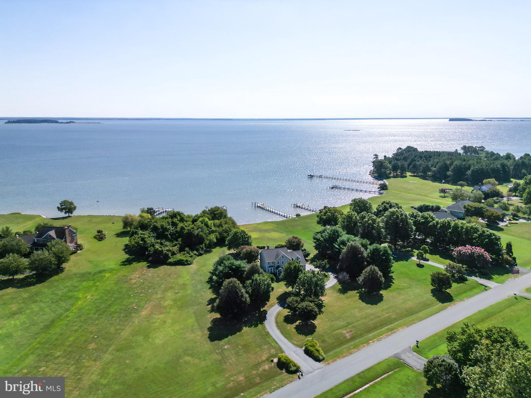 This is the waterfront dream home you’ve been waiting for! Are you looking for expansive bay views from your forever home or second home on the Eastern Shore? This 5 BR, 2.5 BA property with 110 feet of rip rapped waterfront delivers with 2.9 manicured acres (one of the largest lots in the community!) in the serene upscale community of Southwind. You will enjoy this secluded setting with wide sweeping water views surrounded by Crab Alley and Eastern Bay. Just steps down the back yard is the six-foot wide pier with both boat and jet ski lifts and a gorgeous custom salt-water pool surrounded by a pristine paver patio and walkways. Enjoy boating, jet skiing, fishing, crabbing or just relax on the pier and enjoy your morning coffee as you soak in the sunrise! The backyard oasis includes screened porch, two-level Timber Tech decks and waterside fire pits set up for bay view entertaining and fun, fun, fun!
This gem has been lovingly cared for every step of the way and is in pristine condition with a major remodel in 2015. This is a rare opportunity and the first time this property has been on the market. Marvel as you enter into gleaming blonde hardwoods throughout the first floor and upstairs hallway of this 3,718 finished square foot home. Seven rooms on the water side have wide open views of the bay! The foyer features an 18-foot ceiling and 9-foot ceilings throughout the first floor including living, dining, breakfast room, kitchen, bathroom, and office/bedroom. There is a wood burning masonry fireplace flanked by custom built-in bookshelves to enjoy in the chilly winter months. First floor also has a office that could be converted to a first floor bedroom or sixth bedroom if needed.
The 1.6-acre communal easement immediately adjacent to the left of the home insures you will have no neighbor to the left adding to the secluded setting. The community of Southwind also offers a boat launch, boat storage, waterside tennis or pickle ball courts, basketball court, waterfront club house for events and year round activity calendar, walking trail with a pair of nesting bald eagles and much more! Close to prime shopping and dining, yet privacy abounds in this upscale neighborhood. Want to go to restaurants by boat? This location is a short boat ride to the Narrows and St. Michaels! Kent Island’s expansive Cross Island Trail with miles of biking, running, and walking trails provides endless opportunities for locals to enjoy all the island has to offer! This is a MUST SEE!