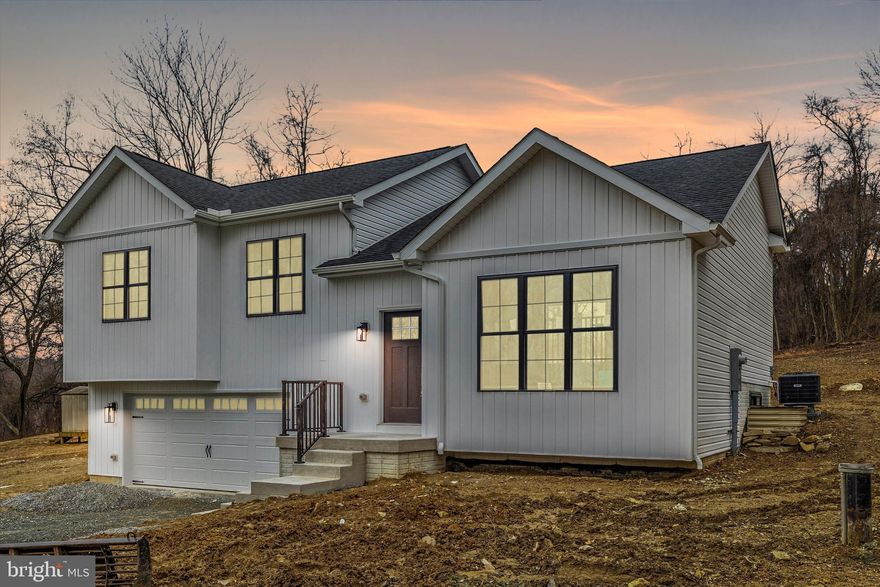 Why wait for your new home to be built when this beauty is ready for you? Situated on approximately half an acre with no HOA, it offers both space and freedom. Featuring an open floor plan, this three-bedroom, two-bathroom home boasts a modern design with cathedral ceilings in the main-level living area. The beautiful white kitchen includes stainless steel appliances, granite countertops, and a custom backsplash. The primary suite features a walk-in closet and a private bath. Durable and stylish LVP flooring runs throughout the home. The finished lower level provides additional space for a rec room, office, or guest area. The two-car attached garage offers ample storage. Don't miss out on this beautifully crafted home—schedule your tour today!