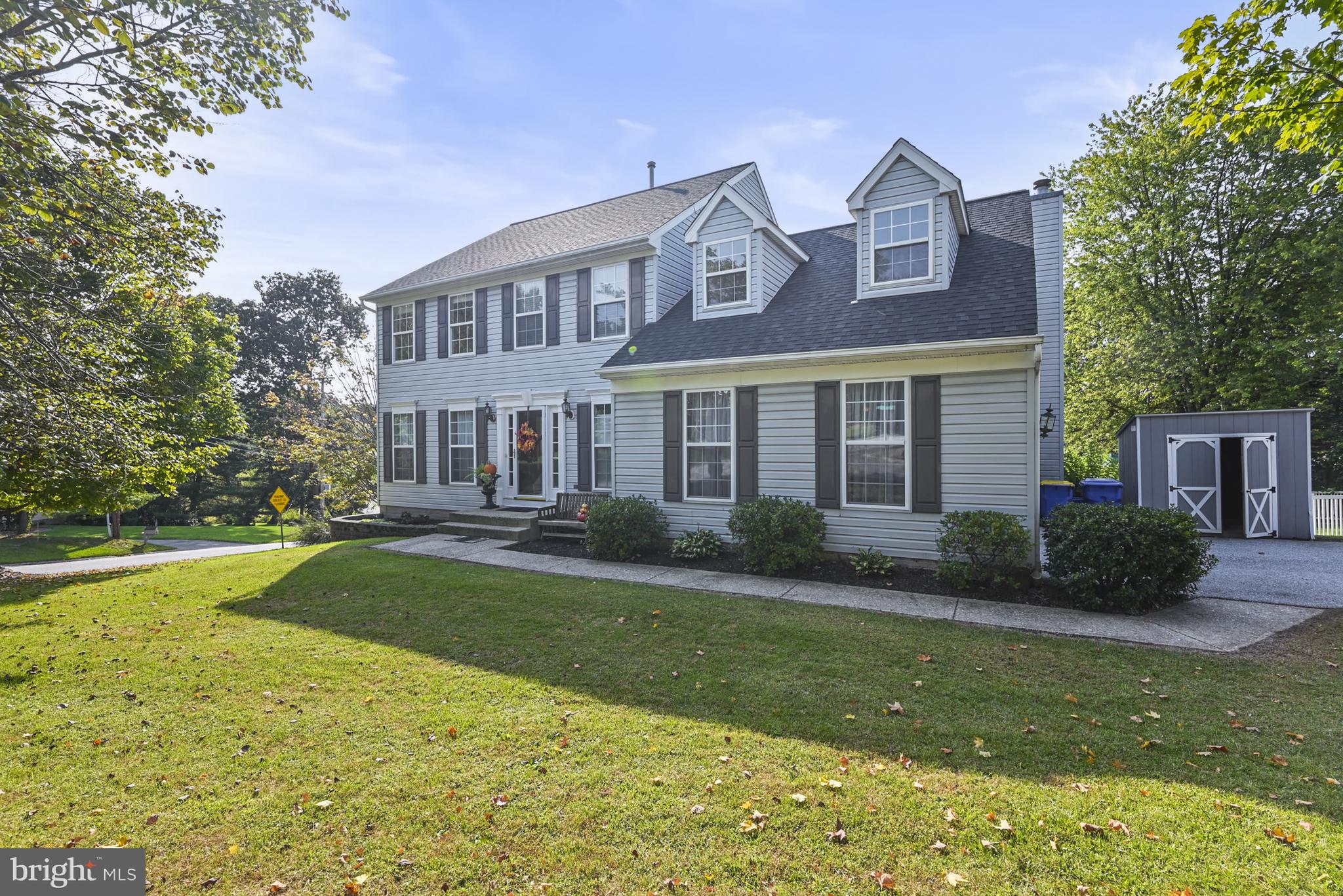 This charming Colonial home, built in 1999, offers a perfect blend of comfort and style with approximately 3,600 square feet of finished living space. Enjoy cozy evenings by the wood burning fireplace in the welcoming family room which is open to the kitchen, ideal for gatherings. The kitchen boasts a granite island with storage and a convenient pantry, and is complemented by modern appliances including a built-in microwave and dishwasher. The Laundry Room is conveniently right by the kitchen. From the deck overlooking the fenced back yard, you can keep an eye on the kids or watch the dogs frolic. The mostly finished walkout basement is complete with a full bathroom and provides additional valuable living space. There is an unfinished room which would be a great workshop or workout gym or recreation space or possibly another bedroom. Located in a serene suburban cul-de-sac, this home is surrounded by friendly neighbors and is just a short stroll to local parks. Sidewalks invite leisurely walks. The long driveway, attached garage and ample on-street parking ensure plenty of room for guests at your next party or holiday gathering. Experience the warmth of small-town community living in this delightful home, where every detail is designed for comfort and enjoyment.
