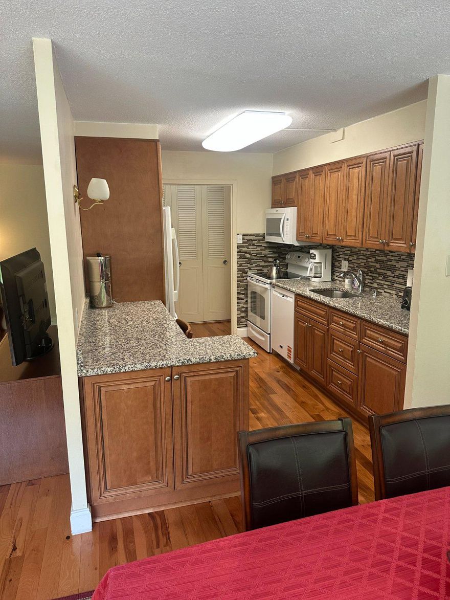 Nestled within the prestigious Green Hill community, this beautifully updated high-rise apartment offers the perfect blend of luxury, comfort, and convenience. Move-in ready and meticulously maintained, this stunning 910-square-foot residence is all you’ve been waiting for — just bring your furniture and start enjoying the lifestyle you deserve.

Step inside to discover an inviting open layout filled with natural light and timeless elegance. Gorgeous hardwood floors flow throughout the living spaces, creating a warm and sophisticated atmosphere perfect for both relaxing and entertaining. The updated kitchen is a true showstopper, featuring modern cabinetry, high-end appliances, and generous counter space that makes cooking and hosting effortless.

Every detail has been thoughtfully designed for easy living, including the convenience of in-unit laundry and ample storage. Large windows frame peaceful views while filling the home with sunshine, adding to the bright and airy feel of the apartment.

Beyond the residence itself, Green Hill offers an unmatched lifestyle with exceptional amenities designed for comfort and recreation. Residents enjoy access to tennis courts, a state-of-the-art fitness center, a community pool, playground, party room, and beautifully landscaped grounds ideal for walking and socializing. Dedicated parking and comprehensive association services — including lawn care, snow removal, and electricity — provide truly carefree living.

Perfectly located near shopping, dining, and entertainment, this home offers both tranquility and accessibility in one of the area’s most desirable communities.

This is more than just an apartment — it’s a turnkey opportunity to enjoy upscale living in a vibrant and welcoming community. Stylish, updated, and completely move-in ready, your new sanctuary at Green Hill awaits.