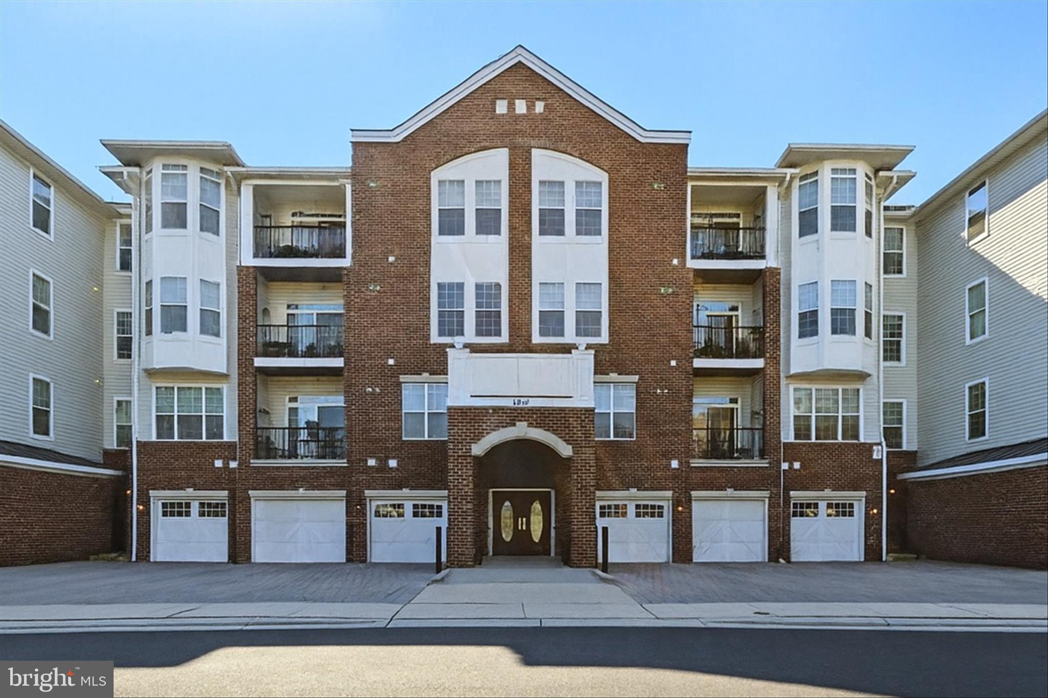 Welcome to The Gatherings at Ellicott Mills, a highly desirable 55+ active adult community in the heart of Ellicott City, Maryland. This spacious two-bedroom, one-bath condo offers the perfect blend of comfort, convenience, and low-maintenance living. Located in a secure building with elevator access, this garden-level home features a bright open floor plan with hardwood floors, large windows, and a walk-out patio for easy outdoor enjoyment. The kitchen is well-appointed with a new refrigerator (2024), gas range, built-in microwave, dishwasher, and stainless-steel double sink. The updated bath includes a walk-in shower (2024) and bidet. Additional highlights include an in-unit washer/dryer, attached one-car garage with extra driveway parking, and annual vent cleaning for peace of mind. The Gatherings at Ellicott Mills offers resort-style amenities, including a clubhouse with multipurpose room, fitness center, social spaces, outdoor pool, and furnished patio. Residents enjoy an active social calendar, plus the convenience of nearby shopping, dining, parks, and major commuter routes (Rte 29, Rte 100, Rte 40). Healthcare access is outstanding, with Desnai Medical Center and Mercy Personal Physicians at Ellicott City less than a mile away, plus nearby pharmacies, physical therapy, and wellness providers. This move-in-ready condo is ideal for those seeking a vibrant 55+ lifestyle in Ellicott City with comfort, convenience, and community right at your doorstep..