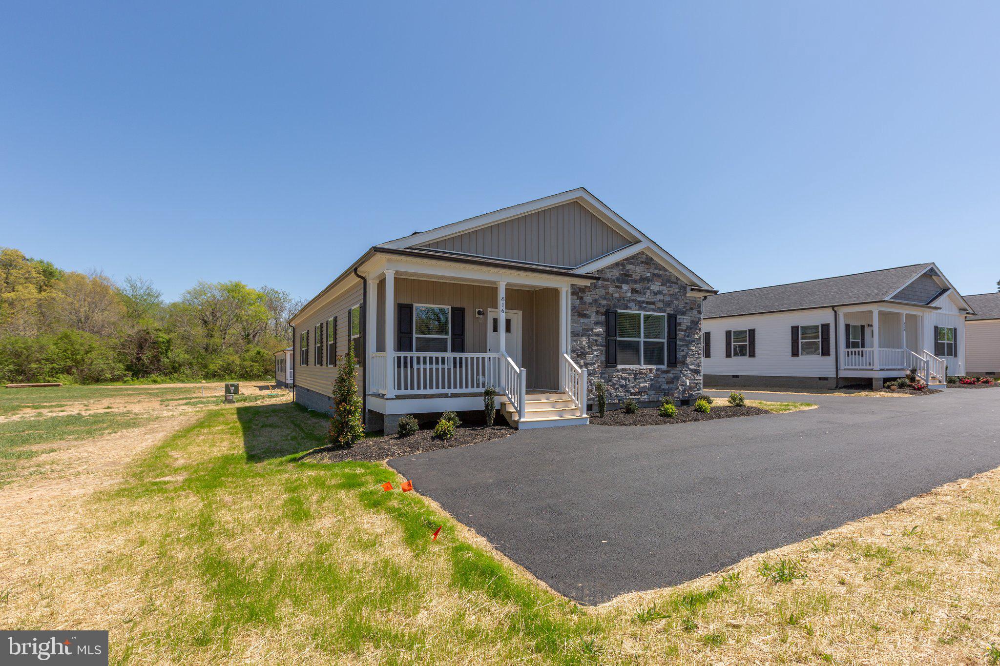 COMPLETE & MOVE-IN READY! New 3BR/2BA home with over 1,700 sq. ft. in the heart of town. Modern finishes throughout including 9’ ceilings, crown molding, black fixtures, recessed lighting, oversized ceiling fan, and shiplap accents. Open kitchen features quartz countertops, tile backsplash, stainless steel appliances, and a large island with ample cabinet space. Dining room includes sliding glass door leading to a 12x14 rear deck with vinyl rails. Primary suite offers a walk-in closet, dual vanities, and custom tile shower. Exterior features a 6’x15’ covered front porch with stacked stone, black gutters/pediments, professional landscaping, and paved parking. Connected to public water/sewer and Xfinity Internet. Convenient location—15 mins to Lake Anna, 40 mins to Short Pump, and 45 mins to Charlottesville. Walk to local park and baseball field. High school with track is 1.7 miles away. Bark Park dog park just 2 miles away. Located in Louisa County which is a top-rated school district—recognized as one of the 2023 Best School Districts in America. Seller will pay for the first year of lawn maintenance. Other lots and floor plans available.