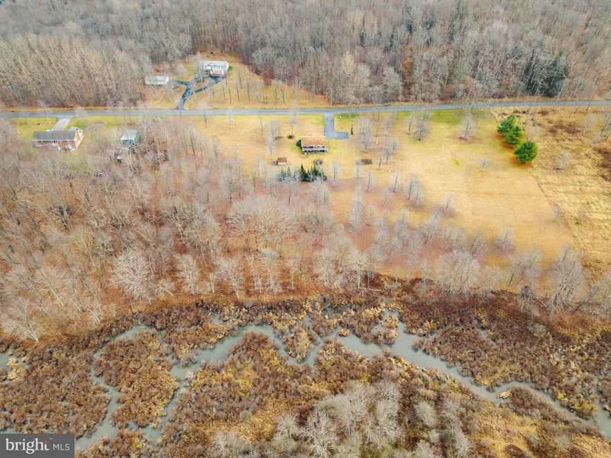 3BR, 2BA rancher on 7+ acres and 600ft+ frontage on Bear Creek! Well-built home in a secluded area, yet central to Deep Creek Lake amenities and Wisp ski resort. Features include laminate flooring, rear covered porch, paved driveway and mostly finished basement with woodstove. Some furnishings negotiable. Includes storage shed on-site.  Property is part of the Bear Creek Highlands HOA but pays no fees.