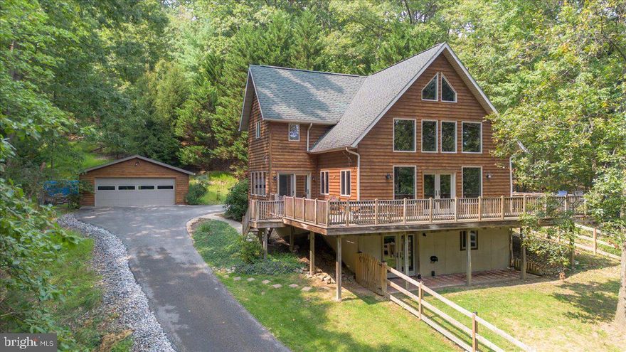 Welcome Home!

Tucked away on 9 private acres and surrounded by trees, this stunning custom-built contemporary A-frame offers the perfect blend of comfort, seclusion, and convenience. Whether you’re looking for a peaceful retreat, a nature lover’s paradise, or simply a place to unwind in complete privacy, this property delivers.

With more than 3,200 sq. ft. of finished living space across three levels, the home has been beautifully maintained. The main level features a fully equipped kitchen with granite countertops, a separate dining room, and an expansive living room with a cozy wood stove. Two generously sized bedrooms, gleaming hardwood flooring, and a tastefully updated full bath complete this level.
Upstairs, the primary suite boasts a private balcony overlooking the wooded property, a full bath, a laundry room, and a versatile bonus area ideal for an office, library, or creative space.
The fully finished walkout basement includes a spacious family room, kitchenette, full bath, and ground-level access—perfect for guests, recreation, or entertaining.
Outside, enjoy an oversized detached two-car garage along with an additional workshop/garage complete with a full second level, offering endless possibilities for hobbies, storage, or even a home business.
This retreat-like setting is less than 10 minutes from Historic Antietam National Battlefield and the C&O Canal, 15 minutes from Shepherdstown, WV, and just 20 minutes to Frederick or the MARC Train in Brunswick. Kayaking, hiking, tubing, shopping, and dining are all within easy reach—yet when you come home, you’ll feel worlds away. With no HOA and no restrictions, the property is yours to enjoy exactly as you wish.

If you’ve been searching for space, serenity, and privacy without sacrificing convenience, this home checks every box. Schedule your private showing today!