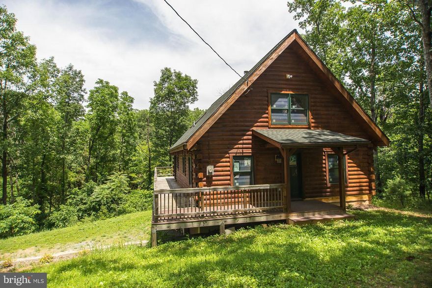 DRASTIC PRICE REDUCTION!  Amazing Log Home,View Of And  Lake Front W/Dock, Finish This Home And Add Your Touches! Log Interior/Exterior, Floor To Ceiling Fireplace,  Loft BR With Full Bath Plan, 2 BRooms On Main Level Each With A Bathroom Plan, Large Open Family Room Kitchen/Combo, With Wood Beams, Spacious Basement With Walk Out To Back Yard And Full Bathroom! Sellers bids to finish $40,000