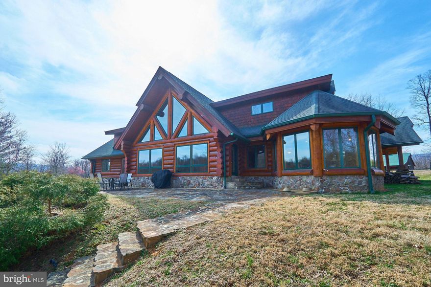 Absolutely Immaculate!  Spectacular Custom built Log Home appropriately named "Silverback Ranch" because each day when the sun sets, it creates a silver hue over the mountain range.   Beautiful property for growing grapes or raising your horses and other creatures!   The Owner, with the help of Builder, Steve Hartman, designed and built this home with meticulous love and care on 27+ pristine cleared &  wooded acreage.  Wanting an escape from the busy city life, the Owner chose this land in 2003 nestled in the rolling hills of Hume and decided to build his dream home and enjoy a weekend retreat among the wildlife of these foothills.  Secure Privacy Gate will greet you and the short drive up the driveway leads you to two different properties: 14045 ($1.5M)  and 14047 (Each for sale). Enjoy evenings sitting on the covered Front Porch. Mahogany Doors allow entry from the side and front of the home.   The structure took intricate architecture to build which included three truck loads of "full round" logs from Sitka Canada; fitting together like Lincoln Logs.  The Floors are all gorgeous Australian Cherry and the Ceilings are Pine. Main entrance brings you to the Great Room which is graced by the Floor to Ceiling Stone Wood Burning Fireplace and the Wall of Windows overlooking the  rear Patio and Lake Linda, a 10 Acre stream fed  Lake which is teeming with Fish, Turtles and Frogs.  Both properties share the lake. for swimming, fishing or small boat rides.  Main Level Master Suite offers a Walk in Closet plus Luxury Bathroom with heated Tile Floors, Wood Vanities, 2 Sinks, Granite Counter Tops, a separate Shower, Water Closet with Toilet and Bidet plus a Free Standing Tub.   There is a Half Bath and another Bedroom or Office with a custom built Wooden Spiral Staircase leading up the Library/Loft.  Main Level also features the Dining Room plus large Kitchen with Center Island and Cherry Cabinets, Granite Counters, Wine Rack and Sub Zero Refrigerator plus the Viking Appliances.  Huge Mudroom/Pantry plus the 2nd Half Bath and Laundry Room.   Upper Level features two more large Bedrooms plus Hall Bath Room & Soaking Tub.  Finally, walking down the custom built Wood Stairs to the Lower Level is the large Rec Room.  the focal point will be the Stone Fireplace.  Light color Carpet creates warmth as you enjoy playing games or relaxing by the fire.    There is another large Den/Bedroom and Full Bathroom.  Plus, an amazing Wine Cellar to store the many Wines collected from one of the local 9 Local Wineries! Walkout to the 5 Car Garage and to the Side Yard.   Next, Gold Cup built the totally Fenced 5 Stable Barn, complete with Plumbing and Electricity plus a Horse Shower!   Upper Level Hay Loft.  So bring your Horses so they can enjoy the 6 Fenced Acres with 3 Paddocks.   The true highlight of living at the Silverback Ranch is the outdoor experience, mostly the rear Stone Patio and steps leading to the Floating Dock on Lake Linda.  The Lake is Totally Private and teeming with Fish.  There is so much nature to enjoy on the property, it Must Be Seen to be Appreciated!  Lake Privileges will convey.  House can be sold with or without furnishings.  Additional parcel consisting of 120 acres, stationary dock and chalet is available for sale at $1,5M,   www.14045HumeRd.com.   Visit our video for more details or www.14047HumeRd.com.  Virtual Tours available  upon request for each property.