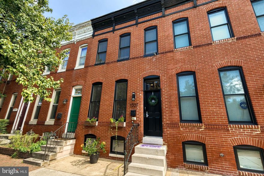 Gorgeous 14.5-foot-wide, 3 bedrooms with an office/den, 3.5 bathrooms, 2180 total finished square foot, recently renovated home with 2 car parking offers incredible features throughout the recently rehabbed property. The handsome brick front with a black front door and trim opens into a very large living room with classic exposed brick walls, coffered ceilings, and crown molding.  Wide plank hard wood flooring runs the length of the open concept main level which is centered around a chef’s dream kitchen with rich shaker cabinets, an extremely large center island with bar seating, granite counters, a pantry or coat closet, and stainless-steel appliances including a wine refrigerator. The dining area set at the rear of the home is spacious enough for a gathering of family and friends and has glass French doors opening to the rear parking area allowing for additional light. A charming powder room finishes the main level. The second level offers a large primary bedroom with exposed brick walls, a tray ceiling, and a spacious walk-in closet. The attached primary bath boasts double vanities and a luxurious walk-in shower. A second bedroom with exposed brick walls and a walk-in closet has access to a well-appointed hall bathroom. A third room upstairs offers functionality as an office or den and gives great flexibility to the ultimate use of the three upstairs rooms. The hallway laundry area is conveniently located on the second level. Interior access from the hallway to the substantial rooftop deck featuring a custom-built wood pergola and controllable shades gives amazing sunset views and provides a relaxing environment for morning coffee or grilling with friends. The finished lower level has a large carpeted bedroom or living area with a nice sized closet, two windows that provide an abundance of natural light, and a connected full bathroom. A utility room and concrete capped crawl space provide extra storage. A few additional features include built in speakers on every level, customized wood trim throughout, and great storage.  A wide two-car parking pad at the rear of the home is the cherry on top of this stunning property.  CHAP Tax Credit keeps taxes under $5500 per year until 2026. Buyer responsible to verify CHAP info with Baltimore City. This prime location is steps away from the Federal Hill business district, a short walk to the Inner Harbor, stadiums, and multiple parks, and extremely easy access to I-95 including a quick 15-minute drive to BWI. Be sure to view the Matterport 360 Tour located under Virtual Tours on this listing and schedule your tour today!