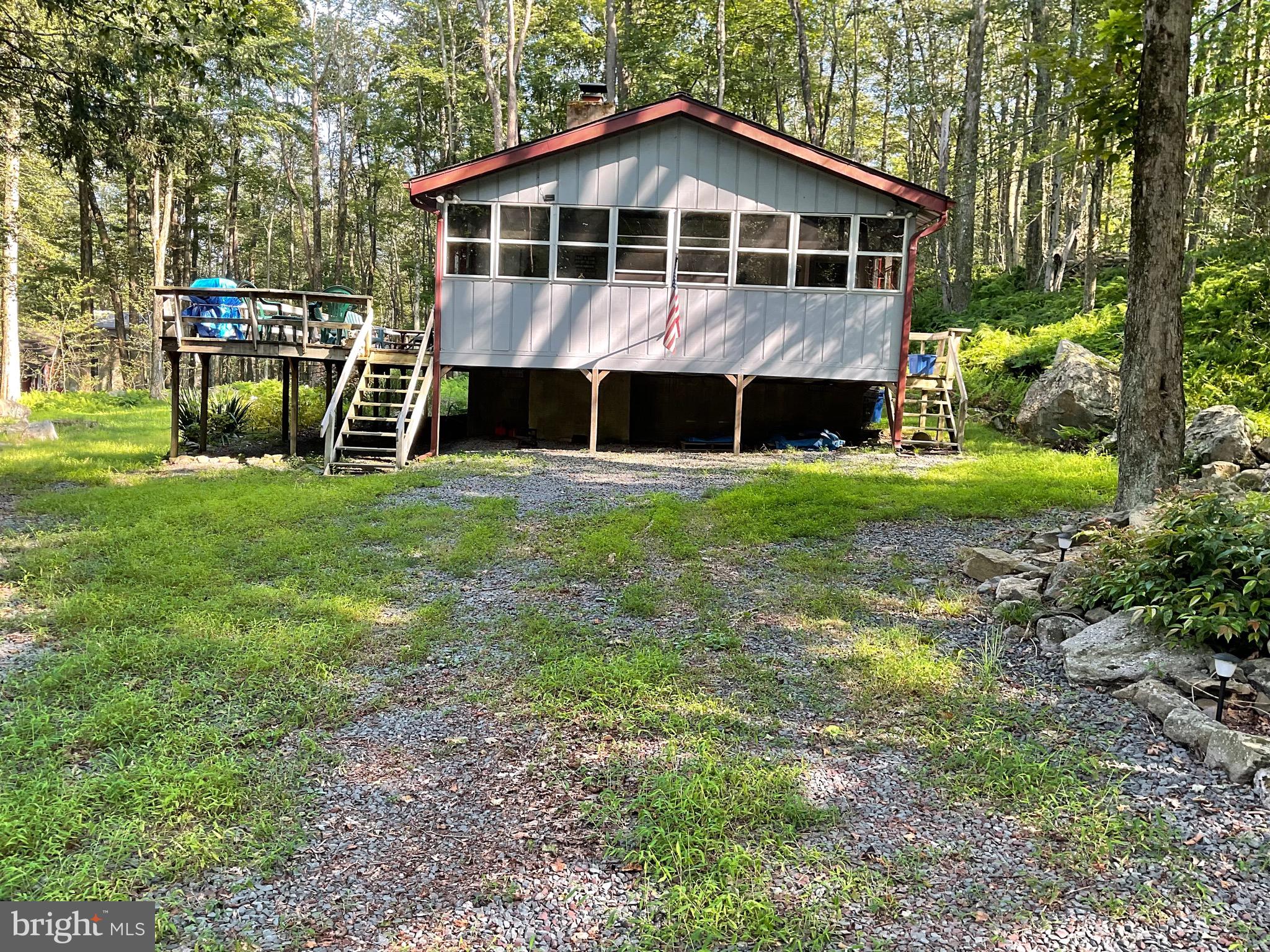 OVER 1 ACRE ON 3 LOTS; ONE SET OF DUES AND TAXES. Walk to sandy beach, playground, Beach 1, fishing, swimming, Boat launch, boat storage, bathrooms and lodge with year round activities. Home completely renovated with 3 bedrooms 2 full baths, laundry room, 3 season room, large front deck to enjoy nature and BBQ. Neutral colors throughout, stone fireplace in living room, with pellet stove insert. Ceiling fans in all rooms, plus granite in kitchen and laminated flooring. Would be a great rental property or getaway for your family.