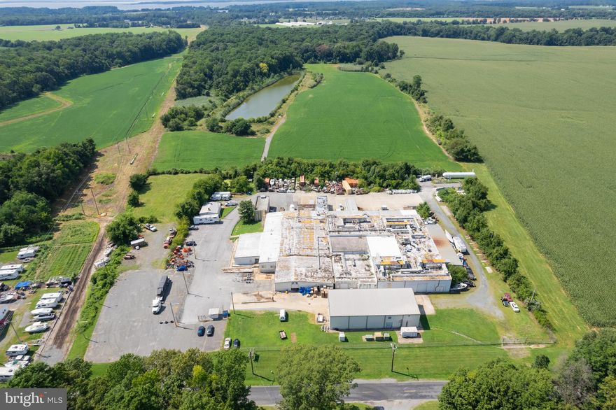 Situated in the heart of Queen Anne's County lies one of its most expansive and strategically positioned industrial sites. Located conveniently on Bloomingdale Road in Queenstown, Maryland, this property boasts unparalleled access to the region's key markets. Just a stone's throw away from US Routes 50 and 301, businesses operating from this site can effortlessly tap into 40% of the nation's population within a mere three-hour trucking window.

Spanning 38.29 acres, the property features a 55,000+ SF industrial facility, once home to the Conagra food processing plant. With the property's sought-after Suburban Industrial zoning within Queen Anne’s County, this location emerges as an ideal hub for a range of industrial activities. Whether you're in manufacturing, distribution, storage, or other industrial sector, the infrastructure and location align seamlessly with diverse operational needs.

Currently operating as a cash-flowing investment property, it houses a blend of 11 indoor spaces and 5 outdoor tenants, each benefiting from the site's strategic positioning. Tenancy underscores the property's potential for consistent revenue, while the month-to-month nature of the existing leases gives the buyer the flexibility necessary to make the site their own.