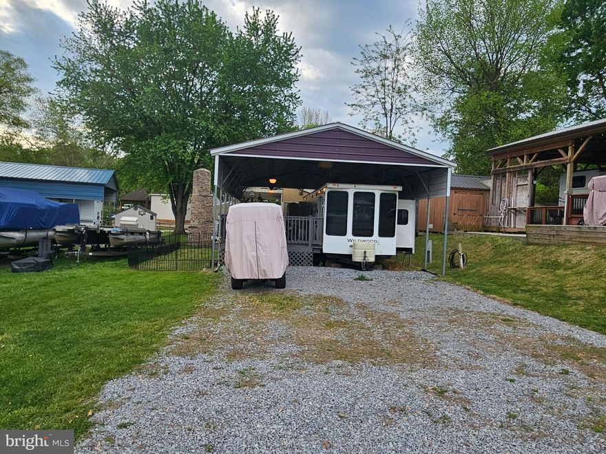Welcome to Block 2 Lot 8 Cindy Ave in Riverbends Rv Campground. 
Riverbend is 400 Acres of SEASONAL recreational campground full of amenities located on the Potomac River in Falling Waters, Wv. OPEN APRIL 1 - NOVEMBER 1
Less than 2 hours from DC, 45 Min from Frederick, MD, and an 1 - 2 hours from VA. Depending on where you live. 

 This is a fun & entertaining community, yet relaxing.

Move in ready lot with a nice metal pavilion that has electric and ceiling fans all covering a large deck and a 2014 Forrest River Wildwood Park model style camper with a sliding glass door into the living room and the Queen-sized bedroom in the rear of the camper has its own entry as well as dual entry access to the bathroom. The table and the couch fold down for extra sleeping space. The large stainless-steel refrigerator on the deck will convey which is perfect for extra food and drink storage while you're camping. There is a nice flat gravel driveway with plenty of parking and a smaller fenced in area for the pets off to the side.  Not all the personal property conveys. See inclusions.

Call today for your personal tour. Approx. 10 miles of Deep water on the Potomac River access for boating, fishing & swimming. Yearly membership ($1,987) plus a $200 initiation fee for new owners, includes water, sewer, electric, trash and the park amenities such as 3 pools, putt putt course, Horseshoe club, Boat club, Poker runs, Trick or Treat, Christmas in July, live bands, basketball court, tennis court, fireworks, car show, Church, restaurant, bar, convenience store (Great food), playground, volleyball, ball field and much much more. Join Riverbend Boat Club. Bring your golf carts, water toys and come enjoy life!