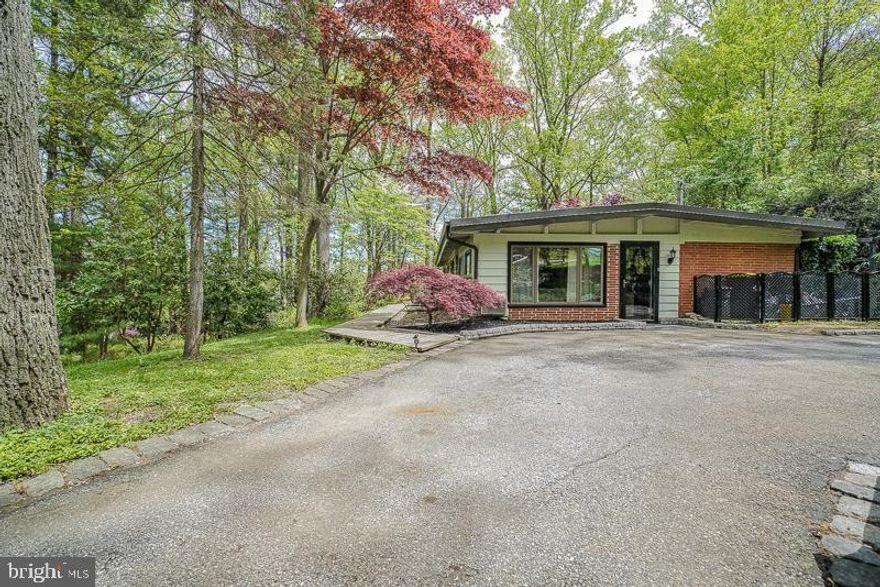 Welcome to this beautiful move-in condition wooded expanded rancher near the Main Line in prime Upper Merion School District in Wayne.  Large inviting front driveway surrounded by an abundance of foliage.  Walkway to formal front entrance and side door entrance.  Formal family room with ceiling fan, custom shelving, and hardwood floors.  Large modern eat-in kitchen with breakfast room, skylights, stool sitting bench, s/s refrigerator, dishwasher, gas(propane) cooking range, ceramic tile, and hardwood floors.  Large formal dining room with fireplace and hardwood floors.  Master bedroom with modern master bath,stall shower with new sink top .  2nd and 3rd bedrooms, modern hall bath.  Exit to several patio sitting areas, deck, and stunning yard views.   Newer state-of-the-art high efficiency heating system, mostly modern windows.   Close to Roberts Elementary School, King of Prussia Mall and Town Center, 202, 76, and Wayne/Strafford train stations.  This is a great price point for the area !! Don't hesitate !!