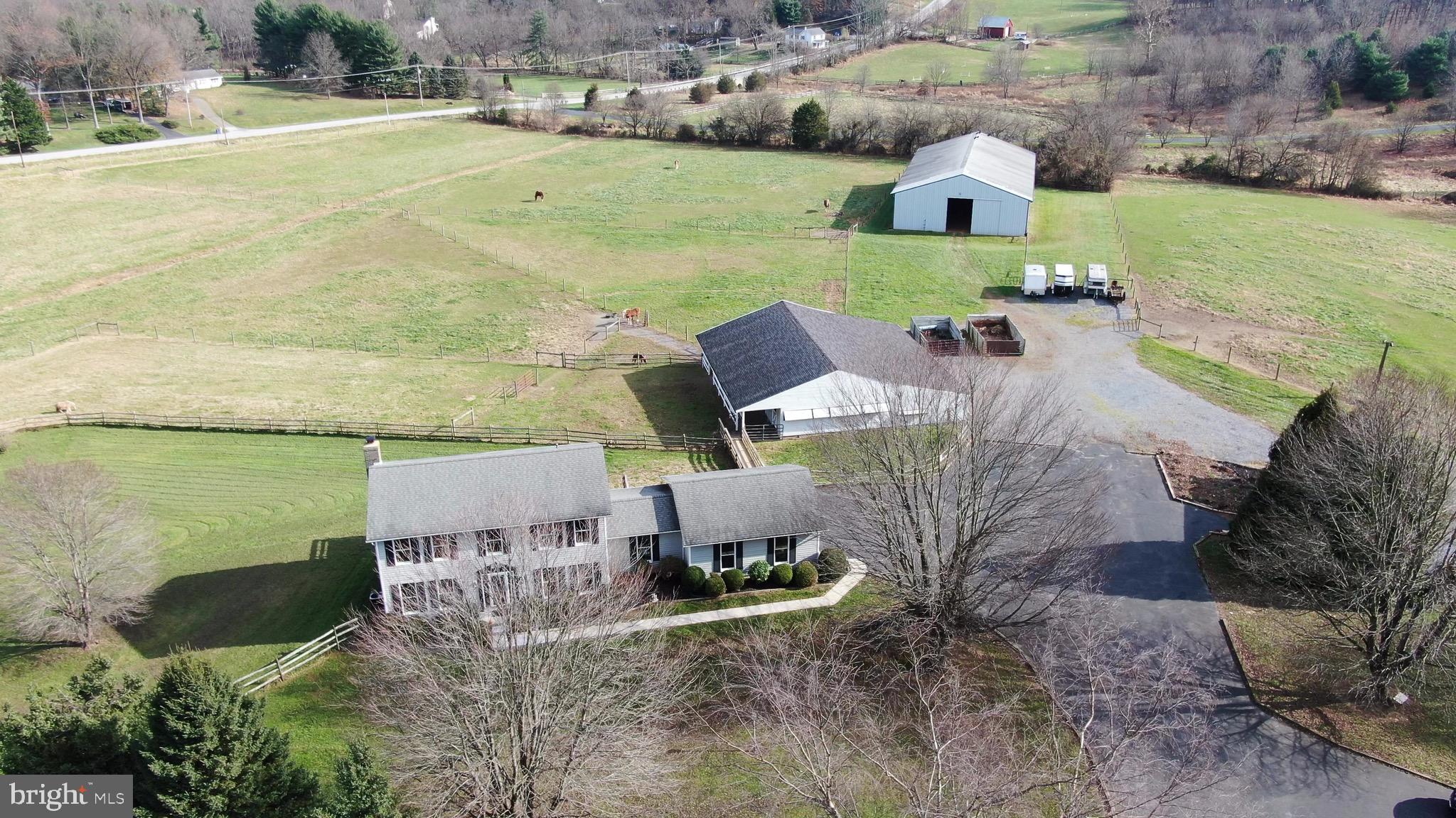 TEN level acres nicely improved for horses. This thoughtfully designed layout of the farm and outbuildings allows for personal use or a small boarding, training , lesson operation. 9+ stall barn with additional hay storage, wash stall, tack room, shavings and manure storage; ample trailer parking & turn around; multiple fenced pastures; 60x120 indoor. Custom colonial home w/ 4 Bedroom, 2.5 Bath, thoroughly maintained by original owners and offers many updates. Beautiful hardwood floors throughout. Cozy family room with masonry fireplace off of kitchen. Spacious deck overlooks multiple individually fenced pastures. Highly rated school system, easy access to major routes. NO HOA. NOTE - Adjacent 7 acre improved property will be available in coming months but a purchase could be considered in advance as the multi family type option can be tough to find. This adjacent property offers a smaller horse operation and similar home with attached in law suite.