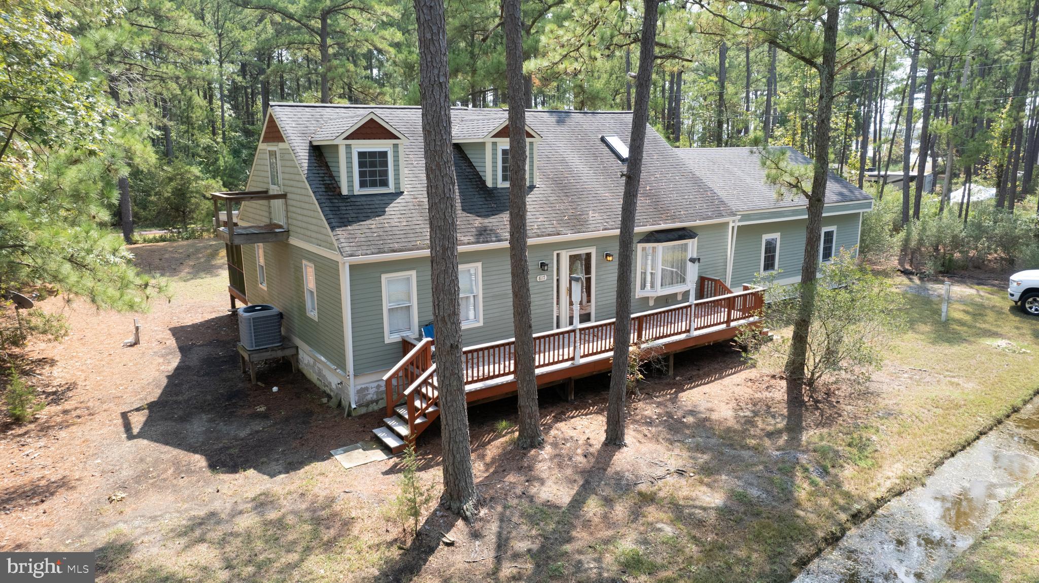SIGNIFICANT PRICE REDUCTION - picture yourself on the back porch of this home enjoying cool summer breezes just steps away from your boat at the community dock! Charming. light filled home with 3 Bedrooms and 2 full baths plus an attached two car garage. Soaring ceilings showing off the post and beams plus gorgeous hardwood floors.
Year round living - the pellet stove provides extra heat. Very cool loft area.
Front deck and large back deck. Pull through driveway.