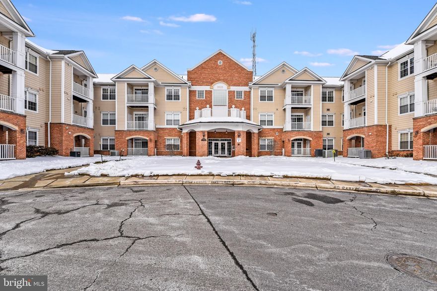 Main Level Unit features easy access to Lobby, Mailboxes, and Community Room.  Also located in the Lobby is the elevator to the Lower-Level Parking Garage.  This Beautifully Decorated Unit boasts Hardwood Flooring, Beautiful Kitchen with Pantry, Breakfast Bar with chairs between Kitchen and Living Room Also includes all appliances to include an extra refrigerator. Floor plan offers 2 Primary Bedroom Ensuites.  Living Room features a slider to a back balcony where you can relax in the sunshine and enjoy a look at nature.  Oversized Laundry/Storage room has washer and dryer and room for storage.  Basement Level interior parking garage with easy access via Lobby Elevator.  Underground Parking Spot has additional area to add a storage unit.  Plenty of visitor parking!  Walk to restaurants and shops!  Close to Multiple Parks, BWI Airport, and Shopping.