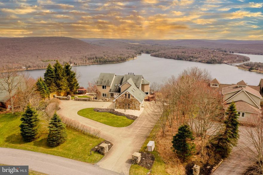 'On Top of the World' - The perfect name given to this established rental with one of the most incredible views in all of Deep Creek Lake. If the views aren't enough,  wait until you step inside this breathtaking 6,000+ sqft home. This home features a gourmet kitchen, 5 bedrooms, 3.5 bathrooms, a sauna, multiple living rooms, a basement set up for all the fun you can imagine and much, much more. Enjoy this one of a kind view while relaxing in the hot tub, sitting by the fire, or lounging on the back deck or patio.  Don't forget to check out your private community marina at the base of the mountain with dock slips available through the HOA. 'On Top of the World' brought in just shy of $50,000 in 2023 (while not being fully available to rent due to owner use) and has multiple previous years  of $100,000+ rental income.  Don't miss your chance to see one of the most gorgeous views and homes in all of Deep Creek Lake.