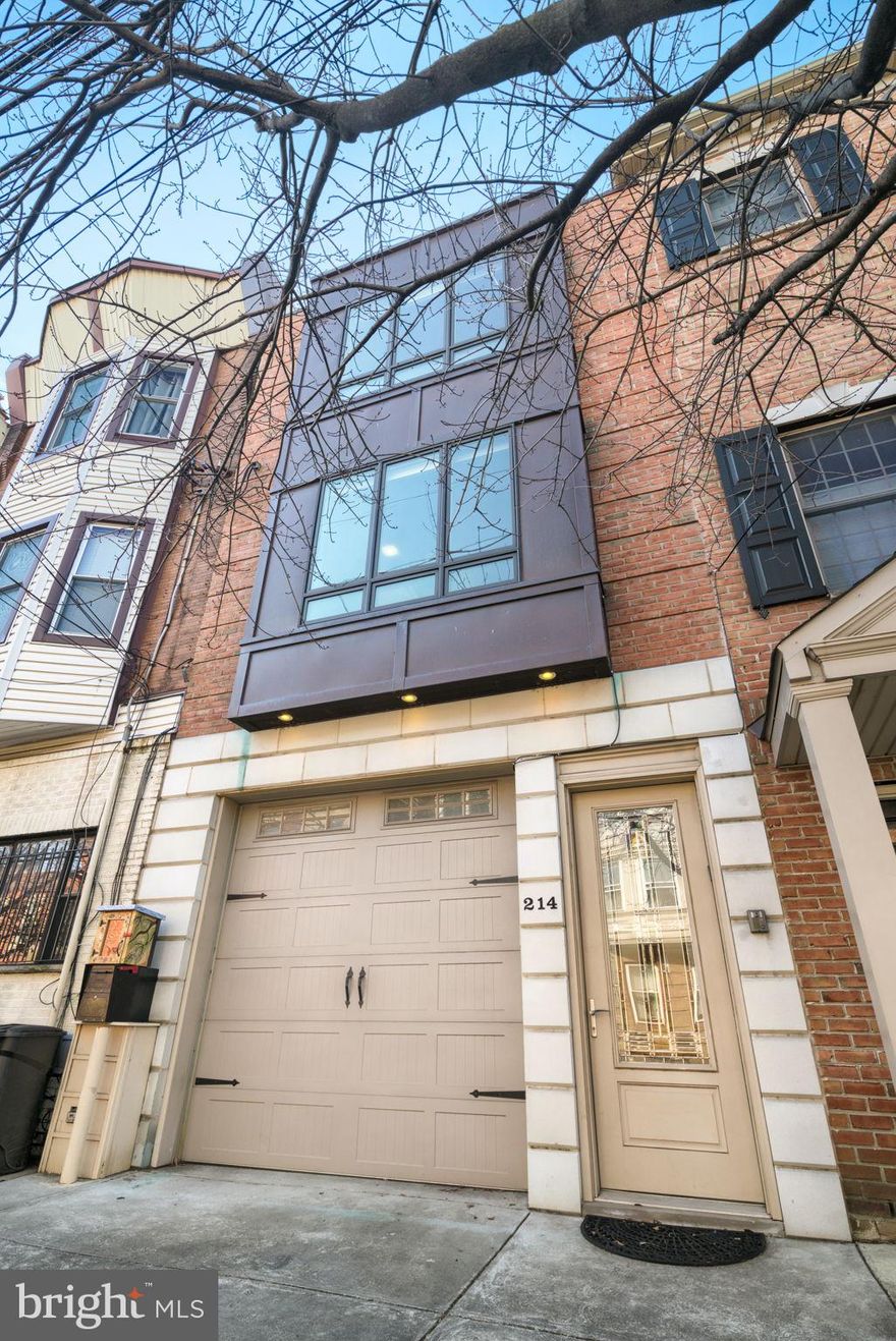 Welcome to the home of your dreams! Situated in Queen Village, this house has a spacious two car garage, 4 bedrooms, 3.5 bathrooms, a den, an elevator, and is an impressive 80’ deep and 16’ wide.
Upon entering this home, you have the first of two indoor entrances to the large two-car garage. The garage has ample room for storage space, with shelving, as well as a closet under the stairs! In the rear of the first floor, through the garage, you also have access to the den. The den has beautiful Brazilian hardwood floors, a large storage closet, a half bathroom, a gas fireplace, and is the bottom floor of the home’s elevator.  
Moving upstairs from the front of the house, you enter into a beautiful open concept living and dining space, perfect for entertaining. The chef’s gourmet kitchen is outfitted with a Wolf range and hood, a Bosch dishwasher, 33” double oversized sink, a Sub-Zero refrigerator, and a large island. This kitchen also has plenty of cabinet and island storage space, as well as a pantry, and has dimmable lights underneath all the cabinets. The oak hardwood is laid in a diagonal pattern, showing off the craftsmanship of the original builder. Directly off of the kitchen is one of four outdoor spaces — a deck perfect for grilling.  Down the hall you’ll find a full bathroom, and one bedroom, with access to a rear deck overlooking the greenery behind the home. Heading upstairs, you’ll be greeted by natural light pouring in from the side windows overlooking the third deck. Hang a left and you’ll get to the next bedroom with an ensuite bath and Murphy bed. If you go to right at the top of the stairs, you’ll find a smaller bedroom perfect for an office or nursery, and the primary suite. The primary suite has two small walk-in closets and a built-in armoire, a large light-filled room, and an amazing bathroom. The bathroom has a soaking tub, a steam shower, a dual vanity, and is entirely Carrera marble. Directly outside of the primary suite is the washer and dryer with additional storage. One more flight up, and you’ve found the crown jewel of the house: the roof deck that spans the entire 80’. Head to the rear of the deck to feel isolated between the willow and the trees, overlooking the garden below, with a perfect city skyline. Entertain in the middle of the deck, with a dedicated gas line to build out your dream outdoor kitchen beneath the pergola. Head to the front of the deck to sip your coffee and look at the city skyline. 
All floors have high ceilings, highlighted by 8’ high doors and crown molding. The thoughtful touches throughout, like in-door blinds, or extra storage space, make this an unparalleled house.